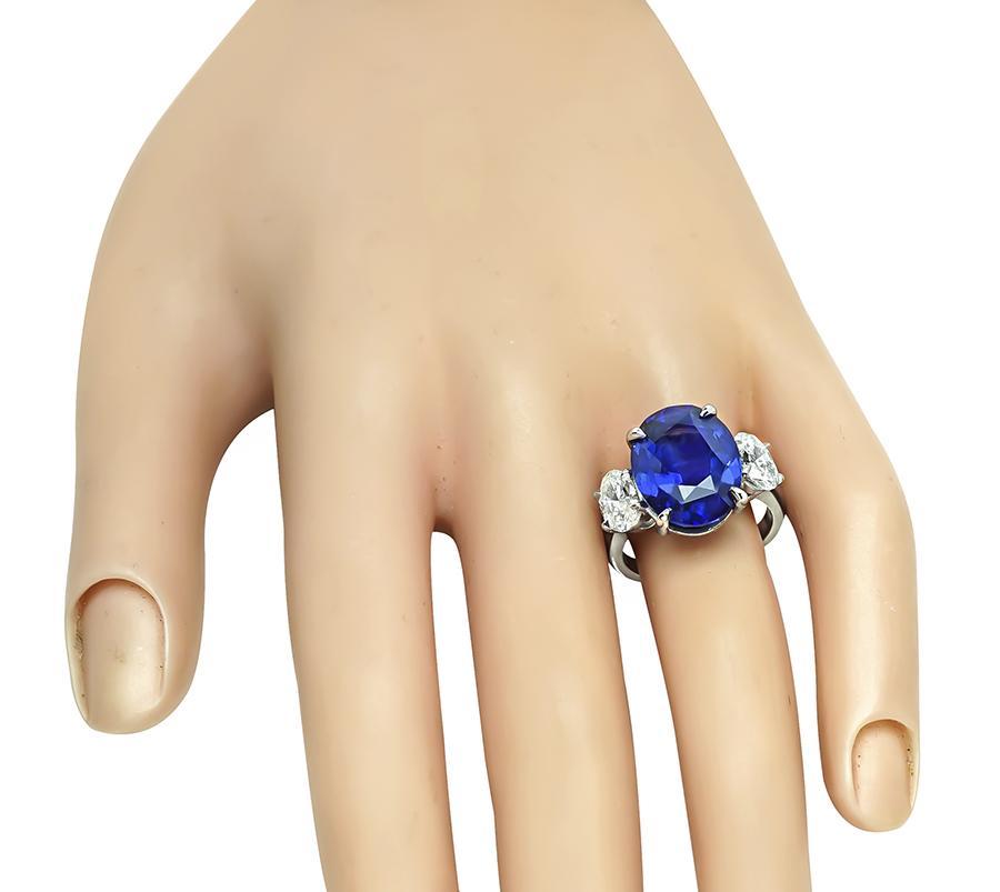 This is an elegant platinum engagement ring. The ring is centered with lovely GRS certified oval cut sapphire that weighs 10.35ct. The sapphire is accentuated by sparkling oval cut diamonds that weigh approximately 1.53ct. The color of the diamonds