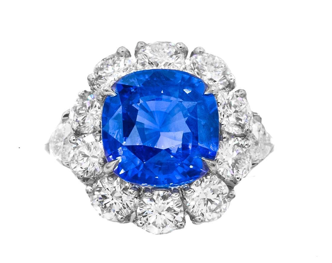 Platinum Sapphire and Diamond ring with  11.11 carats Ceylon sapphire no heat GRS certified set in halo setting with big round diamonds 5.00 carats and two GIA certified heart shapes diamond on each side, 1.00ct total.