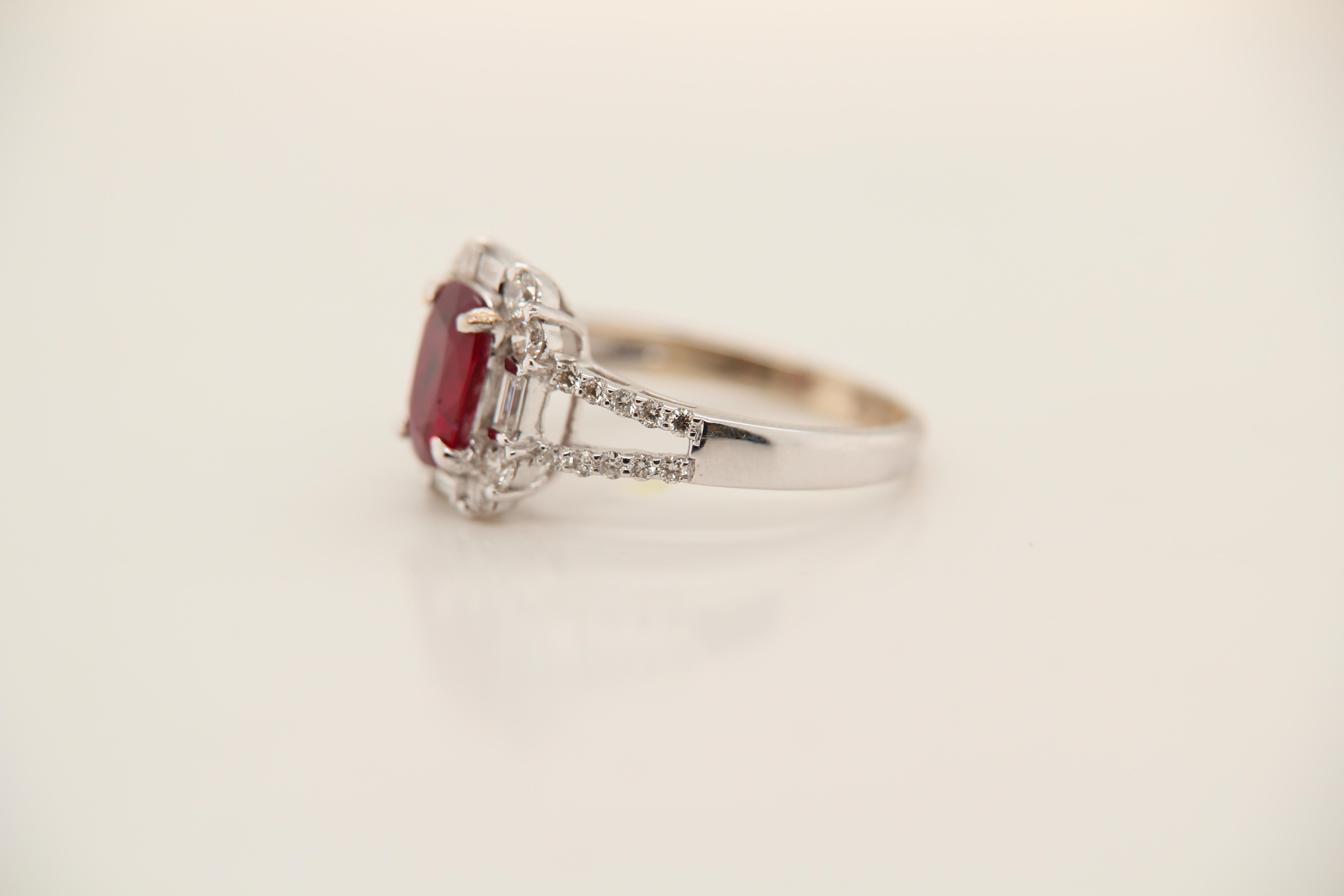 A Ruby and diamond ring. The ring's center stone is 1.24 carat pigeon blood Burmese ruby certified by GRS. The center stone is surrounded by 0.80 carat mix shaped diamonds. The ring can be resized.