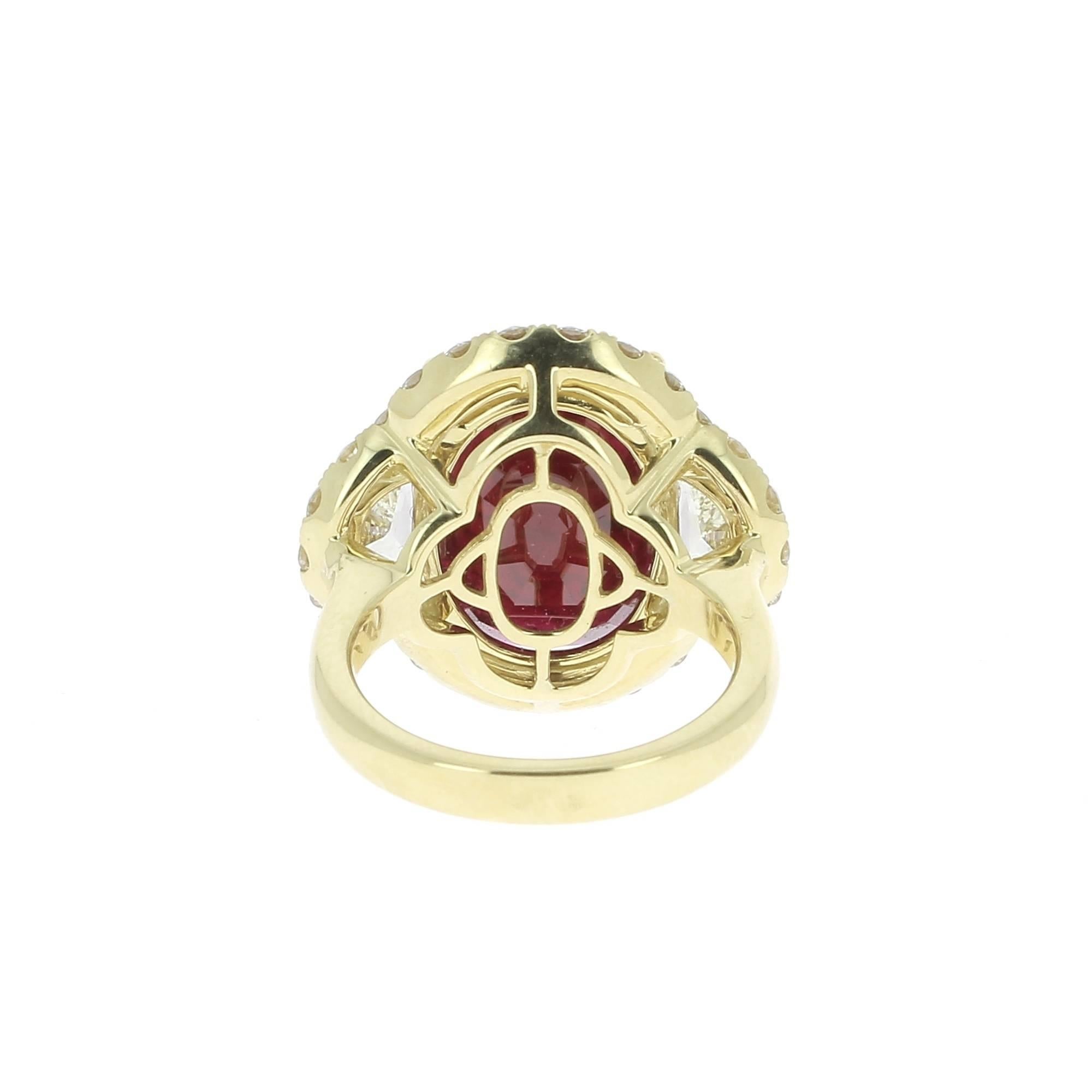Stunning 18K Yellow Gold ring set in the center with a large Ruby weighing 12,52 carat(s) flanked by 2 half moon diamonds weighing 1,22 carat(s), surround with 26 Round Diamonds weighing 1,28 carat(s).
This Oval ruby comes with a GRS certificate