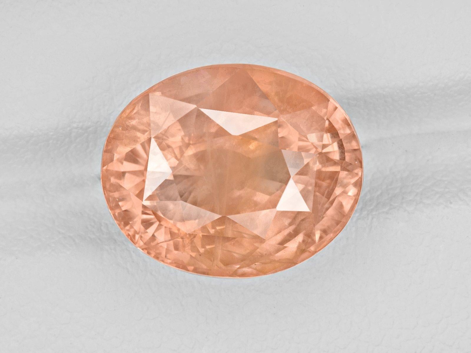A true exquisite sapphire this ring features a rare sunset orange with pink hue Padparadscha sapphire weighing 13 carats. Certified by one of the most reputable laboratories worldwide GRS Switzerland as a true Padparadscha this rare stone is