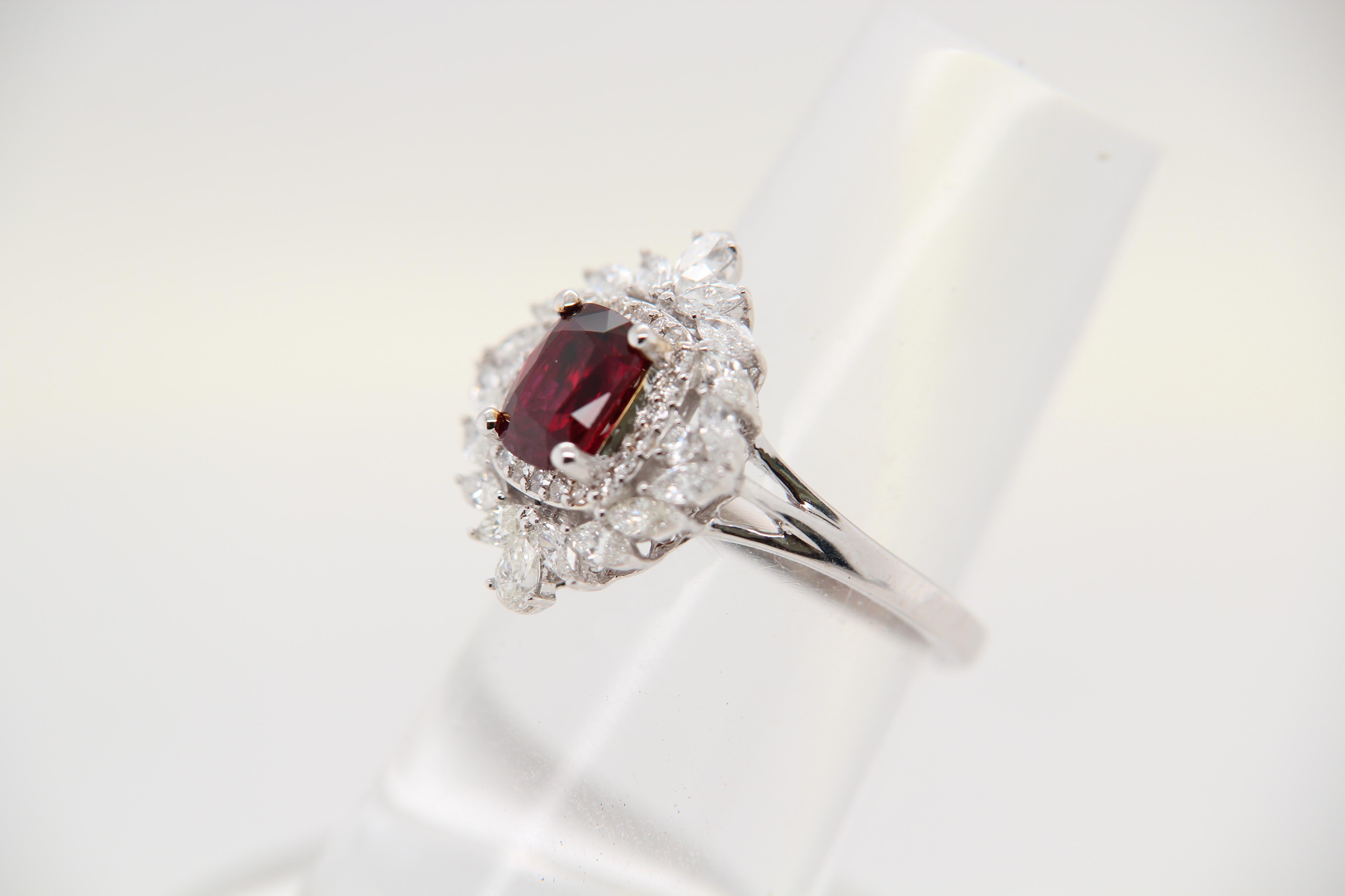 A Ruby and diamond ring. The ring's center stone is 1.34 carat pigeon blood Burmese ruby certified by GRS. The center stone is surrounded by 0.90 carat mix shaped diamonds. The ring can be resized.