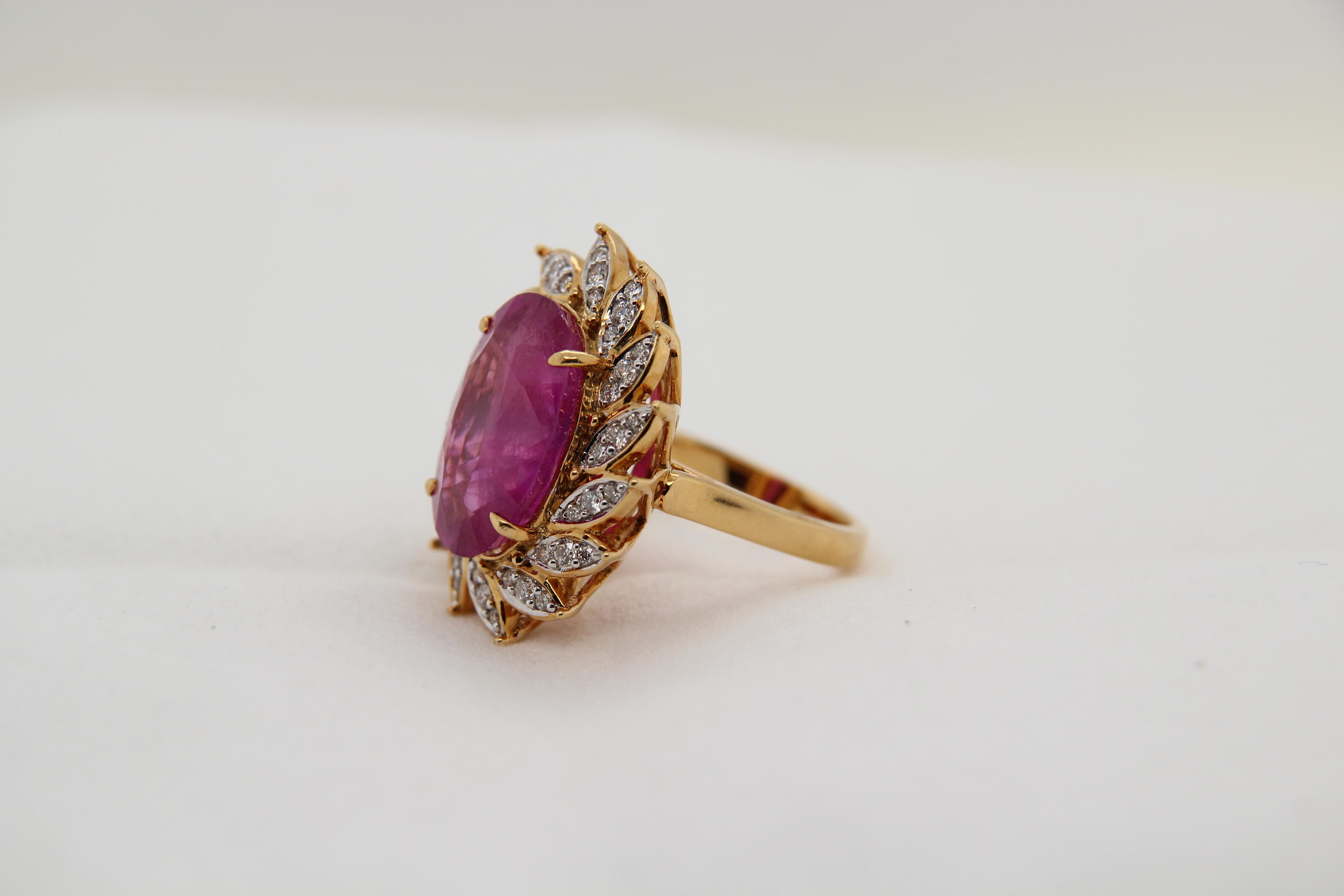 A new GRS certified Heated Burmese pink sapphire ring made in 18 Karat gold. The total ruby weight is 14.24 carats, the total diamond weight is 0.56 carats, and the total ring weighs 13.65 grams. This ring is resizable. 