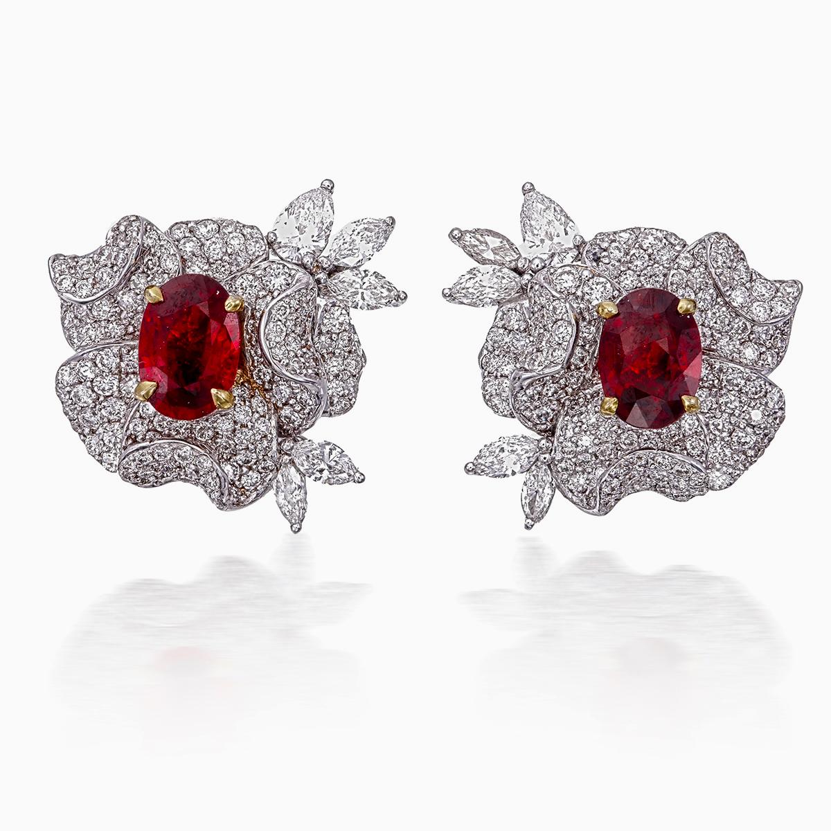 A pair of fine timeless ruby and diamond earrings made in 18 Karat gold. This pair of earrings embraces minimalism with its simple design while still displaying elegance; a great fit for lifestyle wear.

- There are two center oval Pigeon Blood