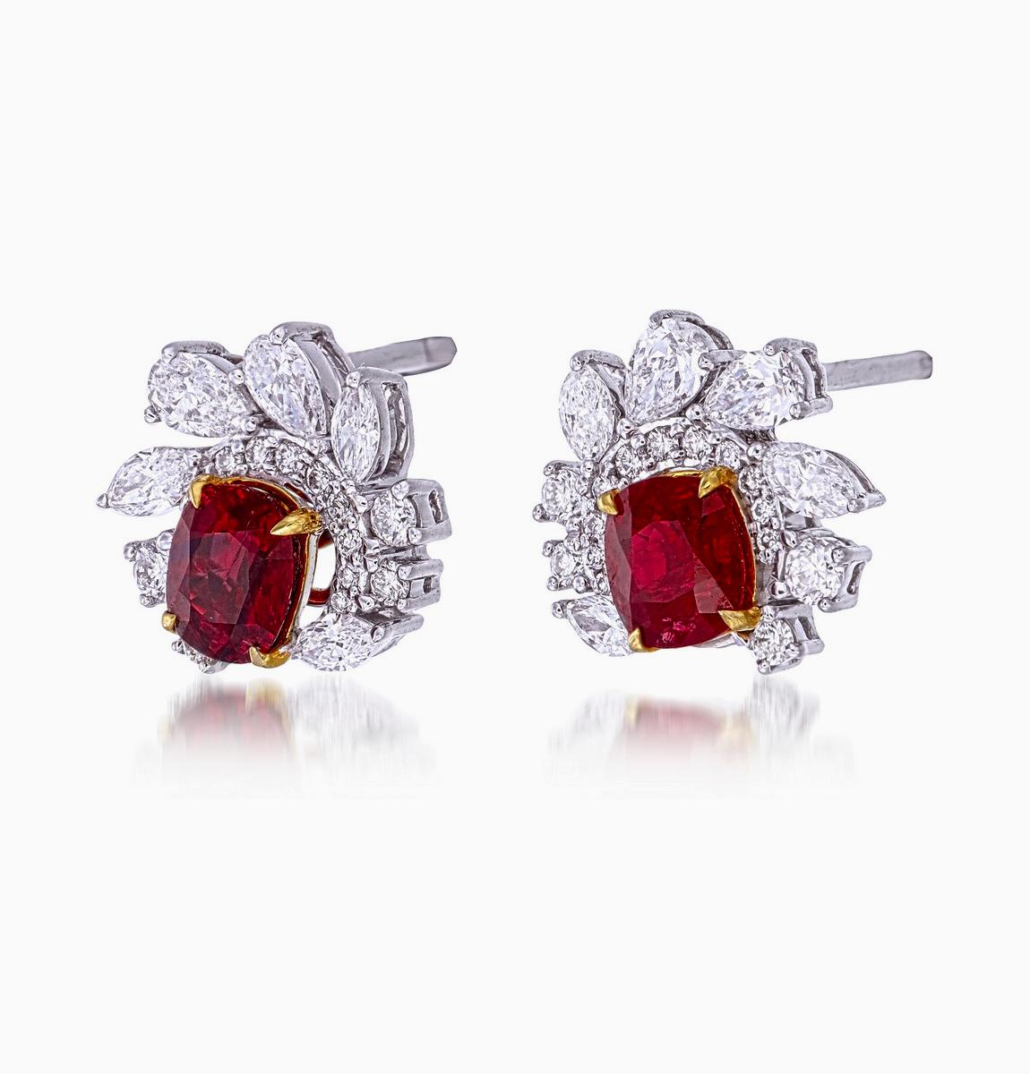 A pair of fine timeless ruby and diamond earrings made in 18 Karat gold. This pair of earrings embraces minimalism with its simple design while still displaying elegance; a great fit for lifestyle wear.

- There are two center oval Pigeon Blood
