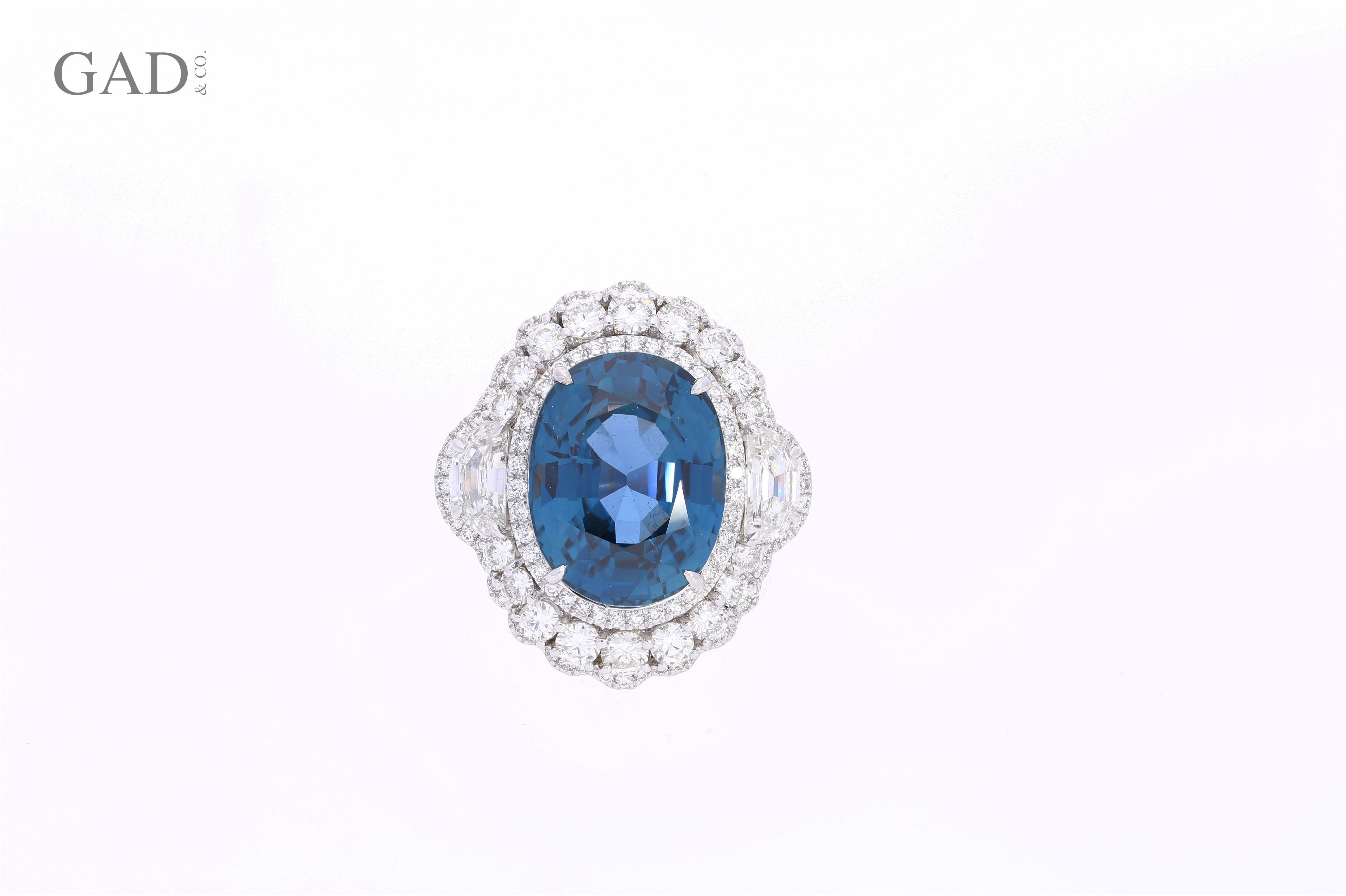Centering a 18.16 Carat Oval-Cut Unheated Burma Sapphire, shouldered by two Half-Moon Cut Diamonds totaling 0.54 Carats, further accented by an additional 306 Round-Brilliant Cut Diamonds totaling 1.54 carats, and set in lush 18K White Gold, this