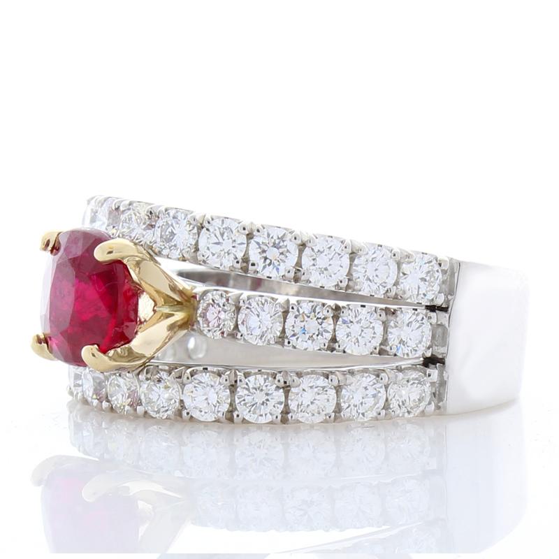 This is a significant 2.01 carat Burmese, vivid blood red, ruby that takes center stage on this stunning triple-row ring in a rich yellow gold accented prong setting with measurements of 7.14 x 6.86 x 4.09mm. Its color is what you want; its luster