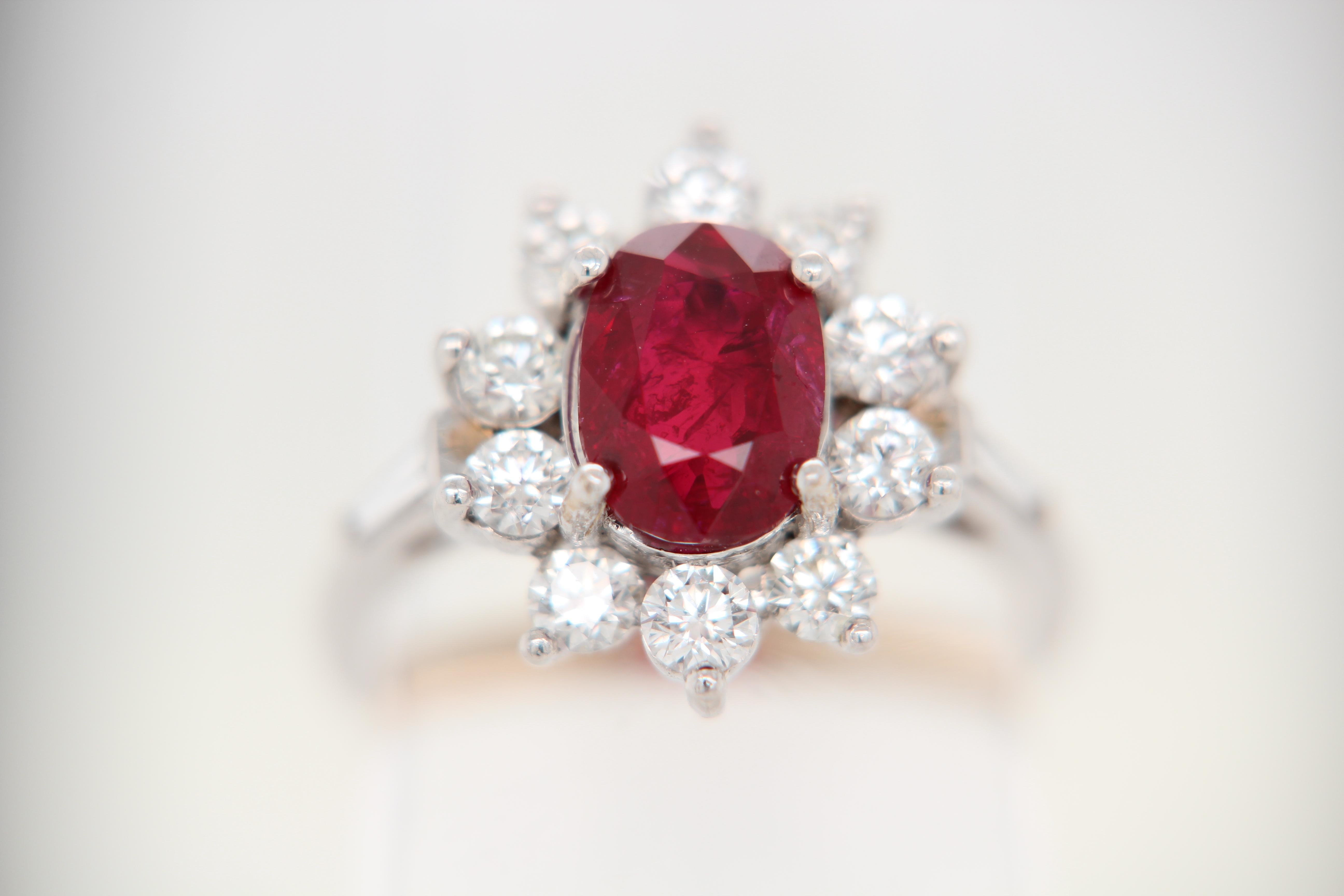 A Ruby and diamond ring. The ring's center stone is 2.02 carat pigeon blood Burmese ruby certified by GRS. The center stone is surrounded by 1.07 carat mix shaped diamonds. The ring can be resized.