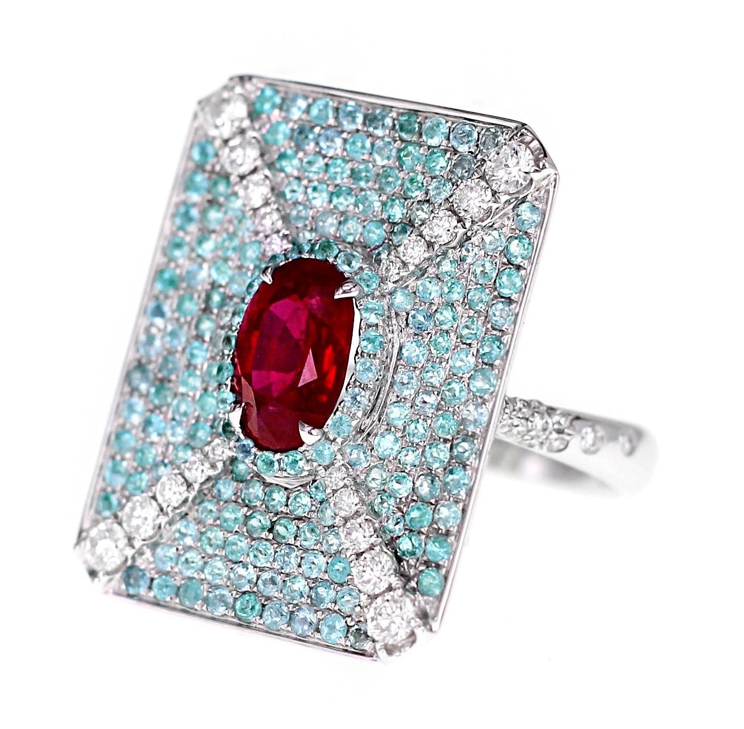 Made in 18 K gold, a lovely combination of GRS certified vivid red pigeon blood color ruby with Brazilian Paraiba are set in this wonderful ring. The ruby is from Madagascar as stated in the certificate. Along with the ruby & Paraiba, 0.61 carat of