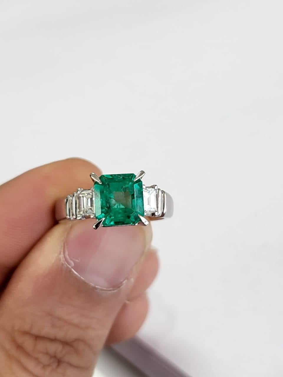 A very beautiful and one of a kind, modern style, Emerald Engagement Ring set in Platinum 900 & Diamonds. The weight of the step cut, octagonal Emerald is 2.05 carats. The Emerald is of Colombian origin has 