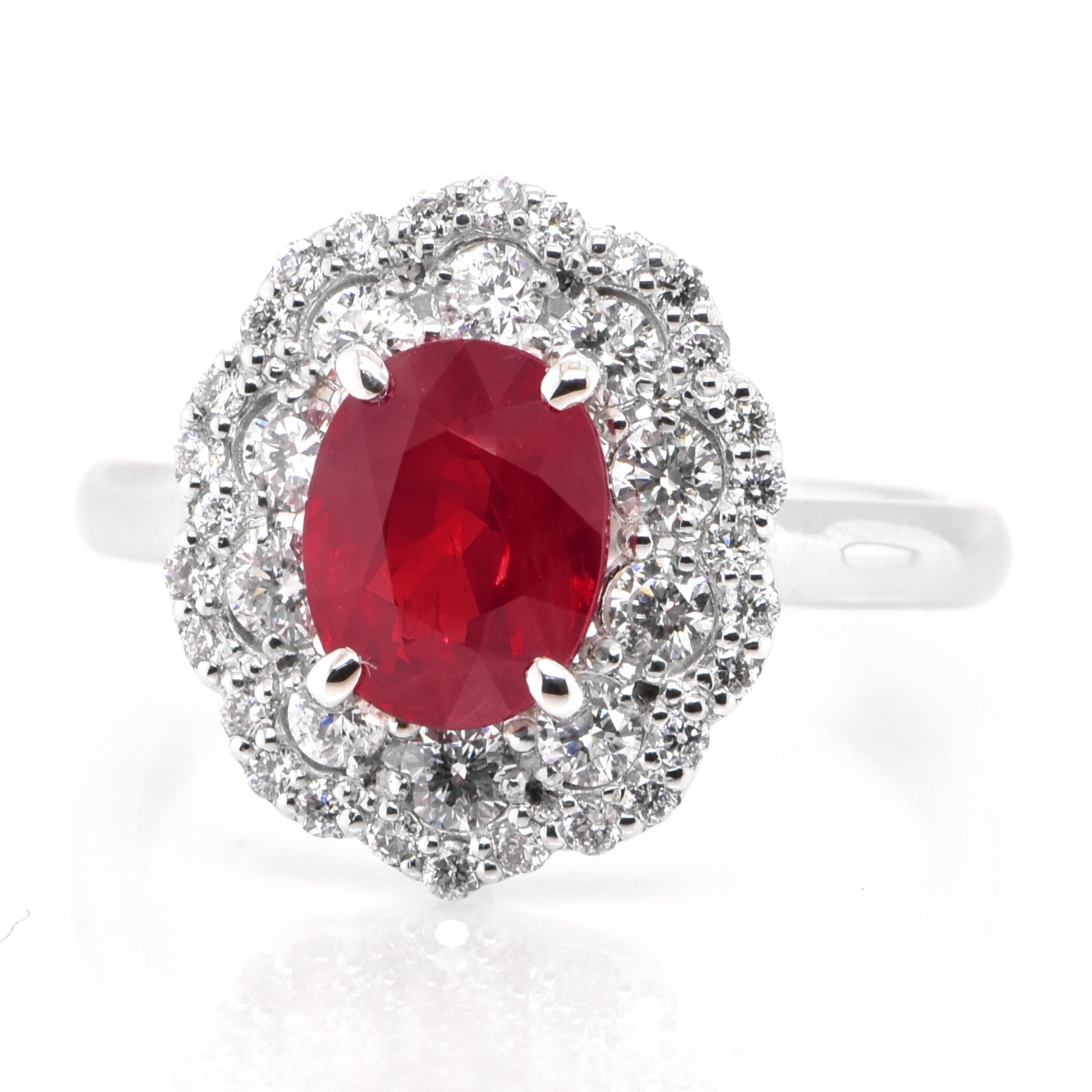 A beautiful Halo ring set in Platinum featuring a GIA Certified 2.06 Carat Natural Burmese (Myanmar) Ruby and 1.18 Carat Diamonds. Rubies are referred to as 