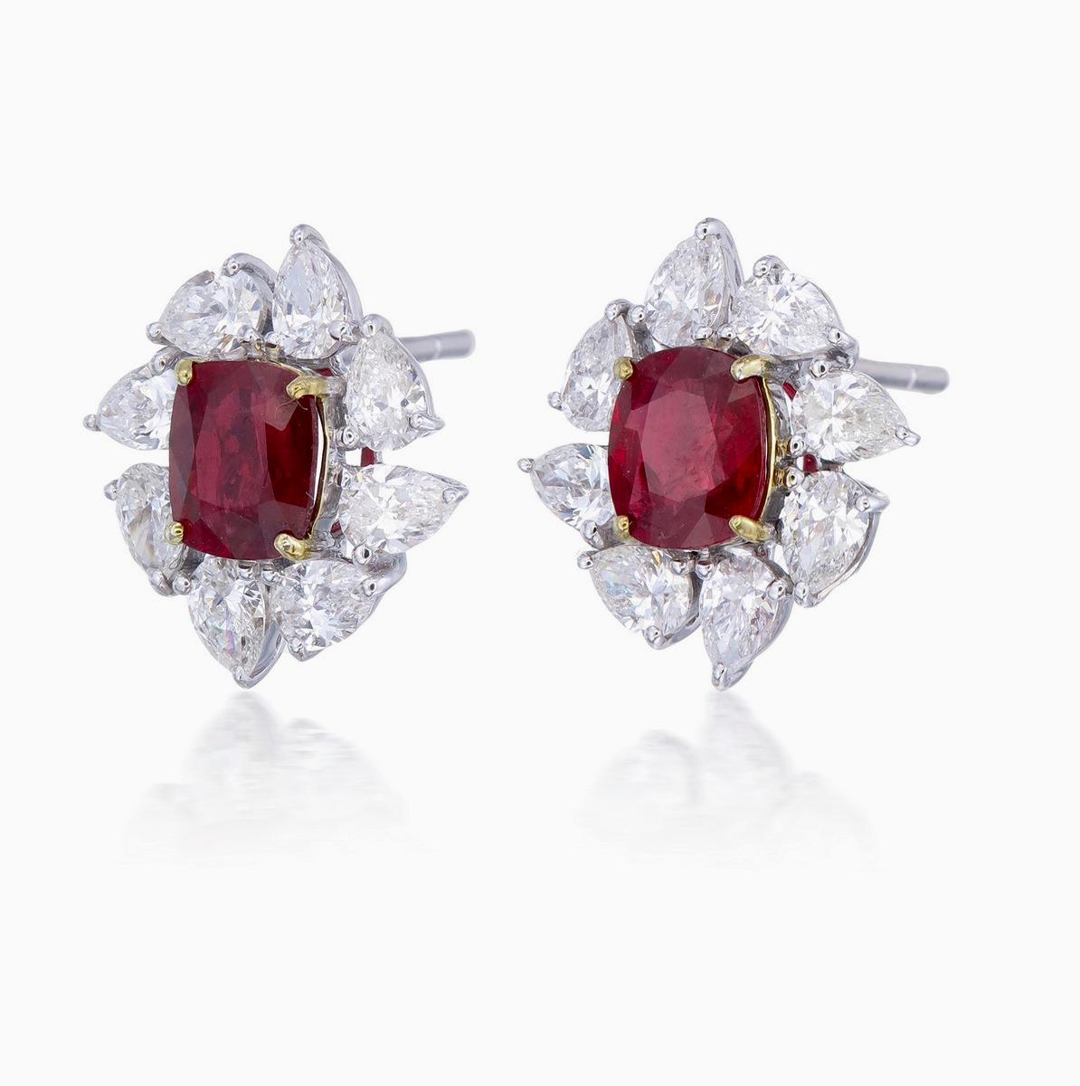 A pair of fine timeless ruby and diamond earrings made in 18 Karat gold. This pair of earrings embraces minimalism with its simple design while still displaying elegance; a great fit for lifestyle wear.

- There are two center oval Pigeon Blood
