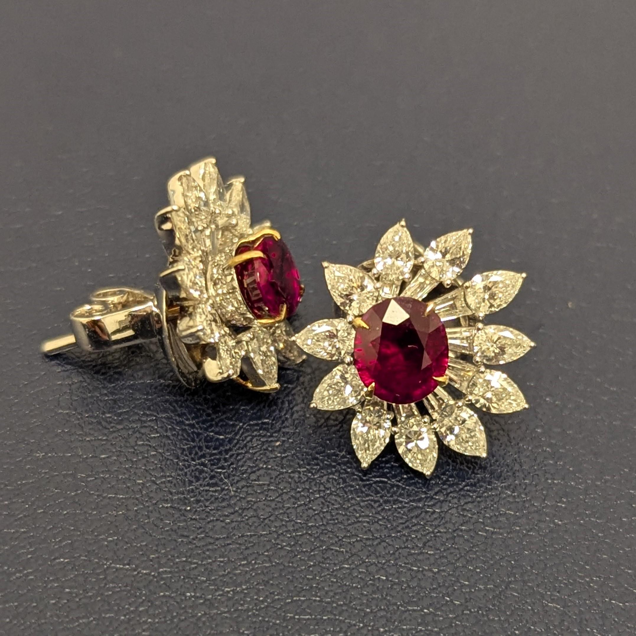 These stunning earrings feature beautifully set diamonds encircling oval shaped rubies, one weighing 1.00 carat and the other longer oval weighing 1.19 carats. The longer oval stone is also more transparent and a little brighter. The unique shapes