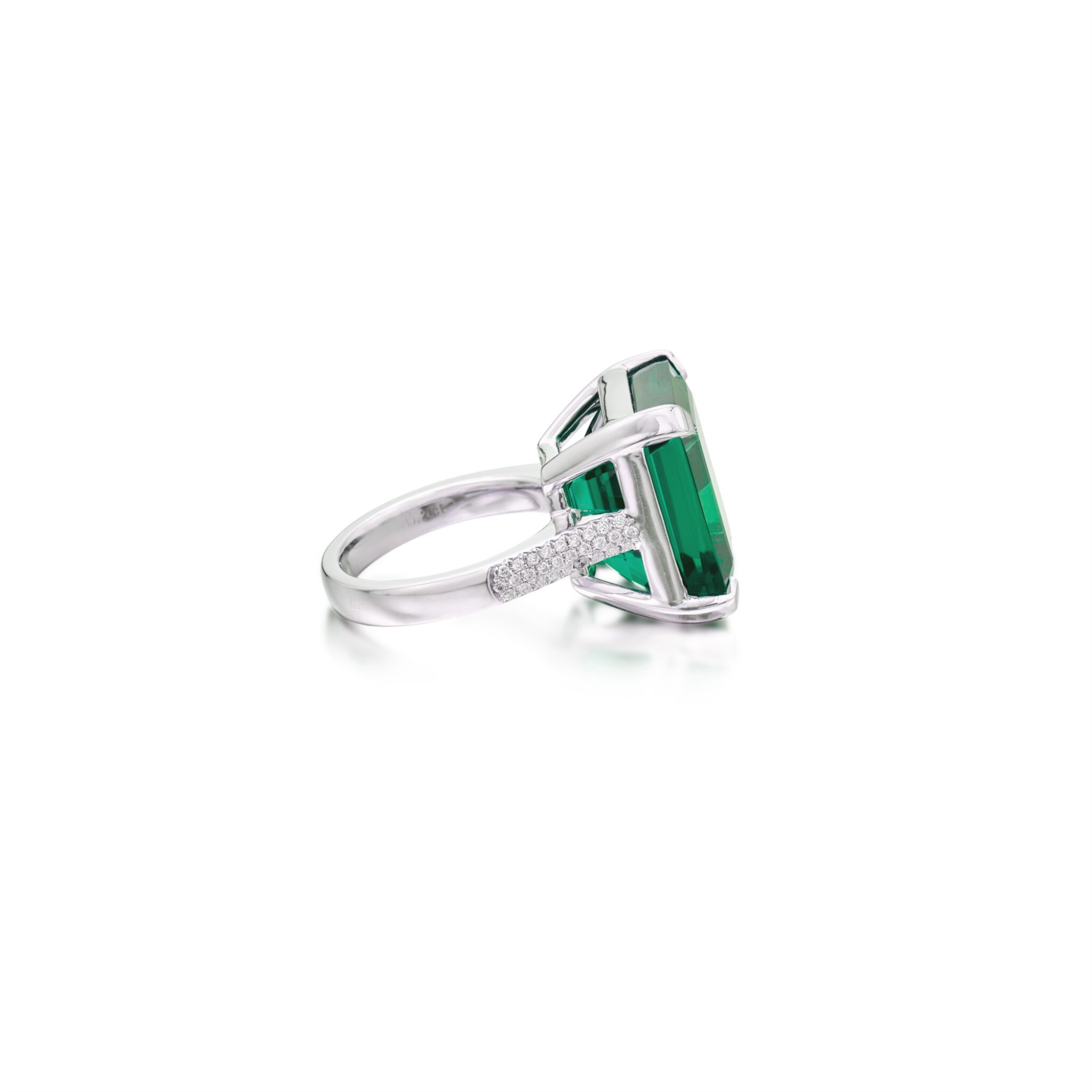 A timeless creation by Cecile Blake, this exquisite ring showcases a vibrant 12.09 carat natural emerald  certified by GRS as insignificant oil

Crafted in luxurious platinum, this ring is a harmonious blend of sophistication and artistry, making it