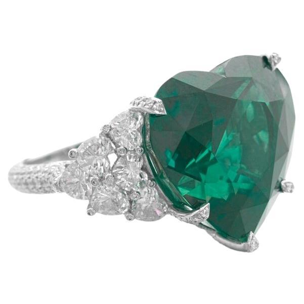 Centering an heart-shaped emerald, flanked by 12 heart shaped diamonds, decorated throughout with pave round diamonds.

emerald weighing 25 carats
Size 7
Platinum
Accompanied by Grs report  stating that the emerald is of Zambian origin, with vivid
