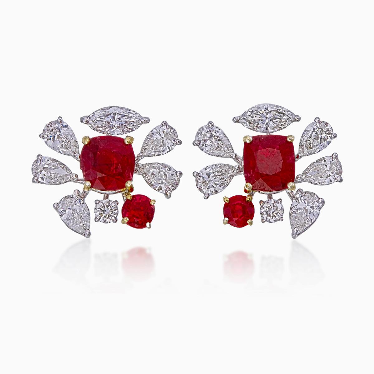 A pair of fine timeless ruby and diamond earrings made in 18 Karat gold. This pair of earrings embraces minimalism with its simple design while still displaying elegance; a great fit for lifestyle wear.

- There are two center oval Pigeon Blood