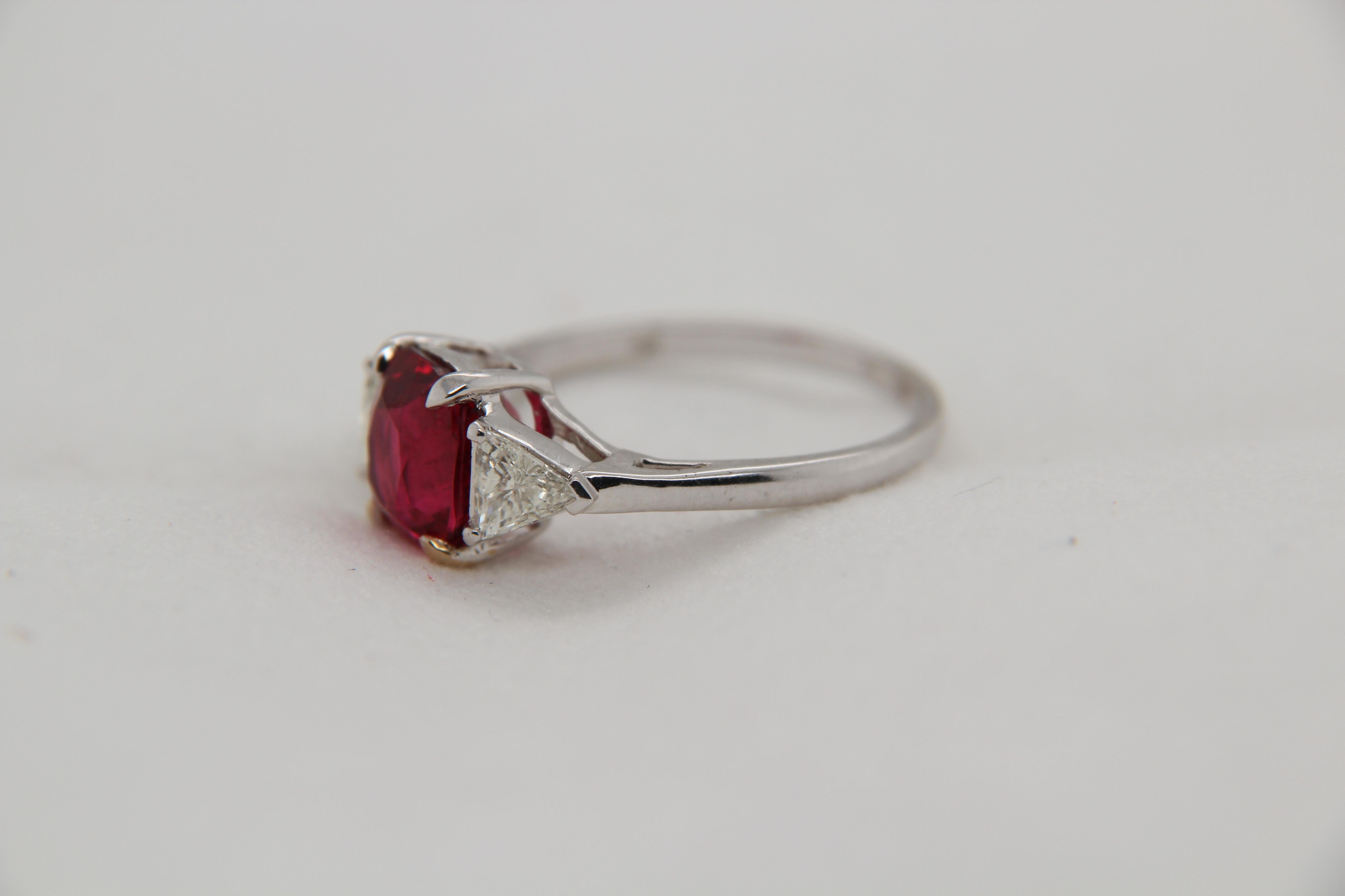 A new 3.04 carat Burmese spinel ring mounted with diamonds in 18 Karat gold. The spinel weighs 3.04 carat and is certified by Gem Research Swisslab (GRS) as natural, no heat, and 'Vivid Red'. The total diamond weight is 0.42 carat and the total