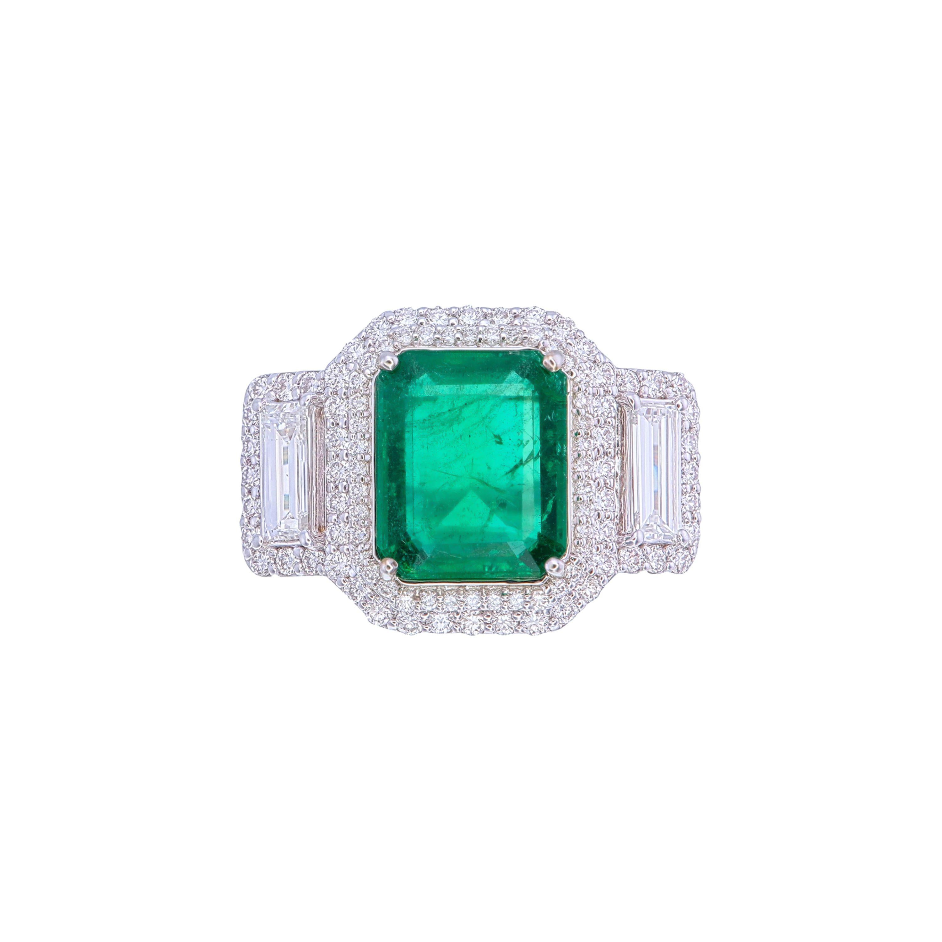 Experience timeless elegance with this remarkable ring, showcasing a vibrant 3.20-carat octagon-cut emerald as its centerpiece. The emerald, sourced from Zambia, radiates a vivid green hue, certified with minor enhancements by GRS, affirming its