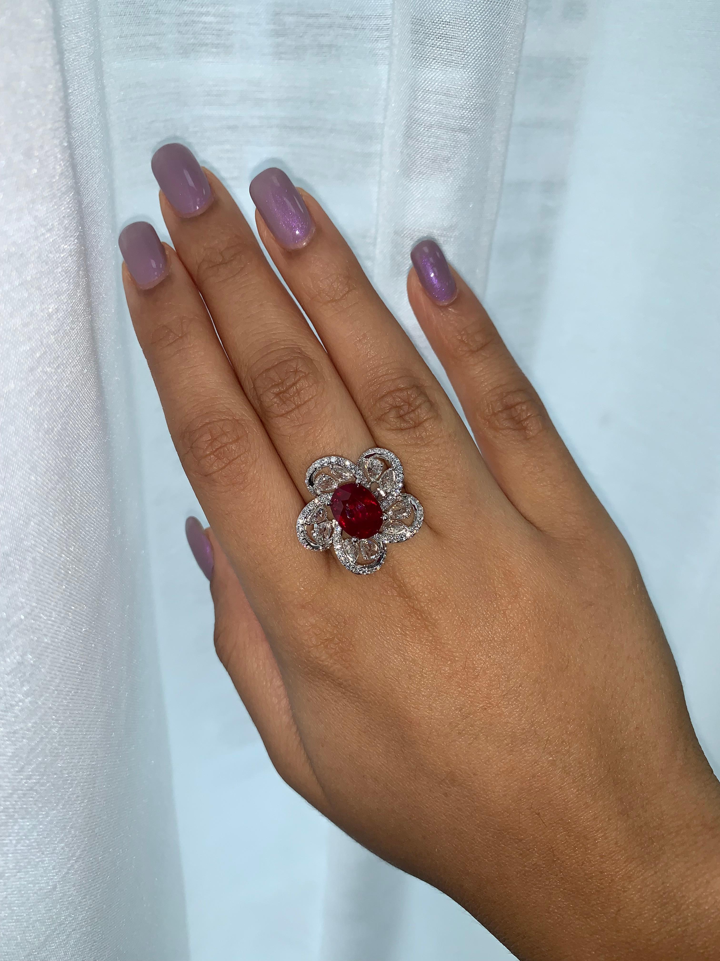Royal Ruby Ring by Sunita Nahata Fine Design. This beautiful gemstone is unique complemented with floating rose cut diamonds, and pave diamonds on the ring. Regal ring for a special occasion. 

Ruby and Diamond Ring in 18 Karat White Gold.

Ruby
-