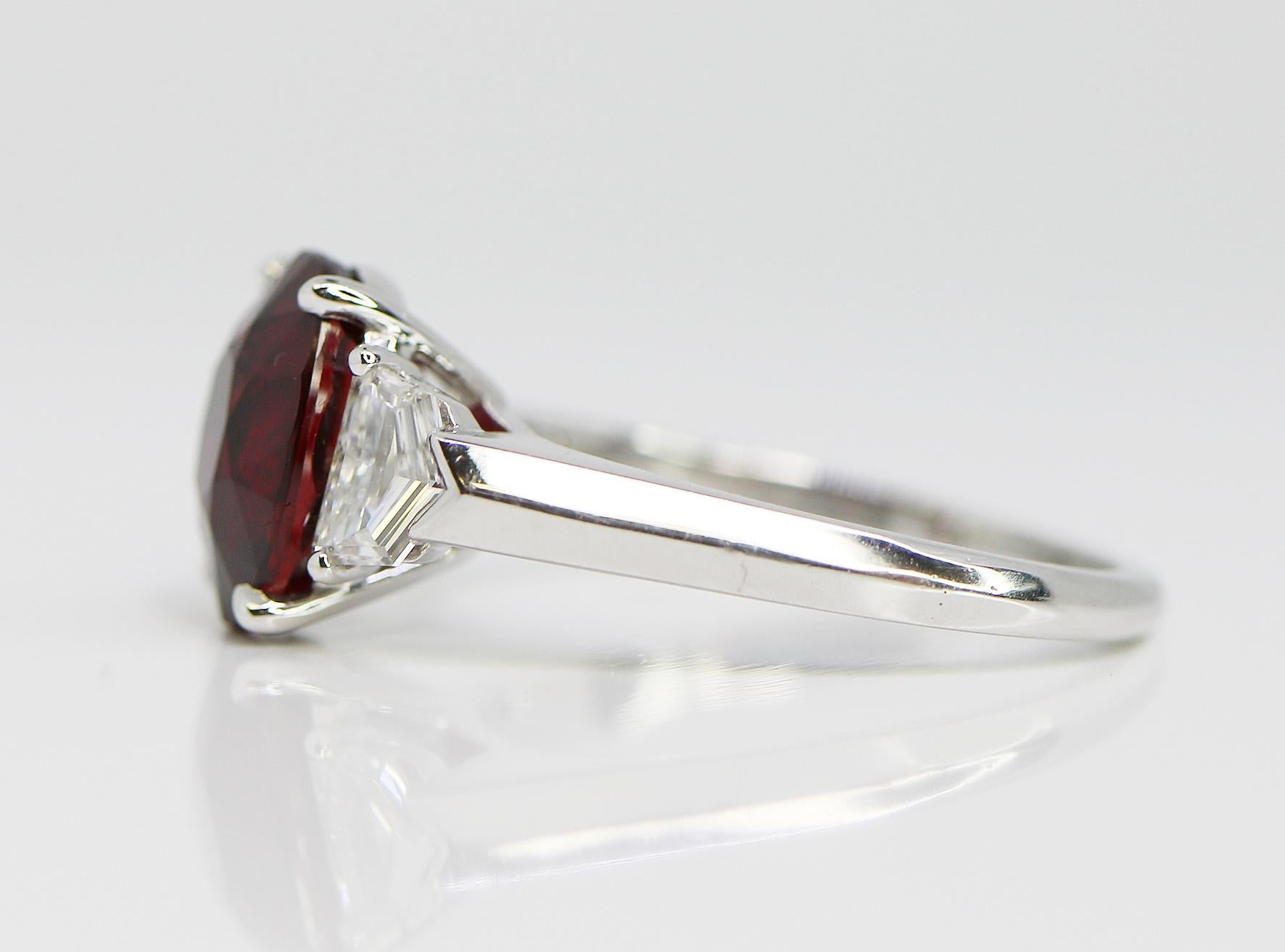 This 4.04 Oval Vivid Red Ruby is set in a Platinum ring. with 2 Cadillac Side Diamonds = 0.56cttw
This Rubi is GRS certified # 2017-0614912 