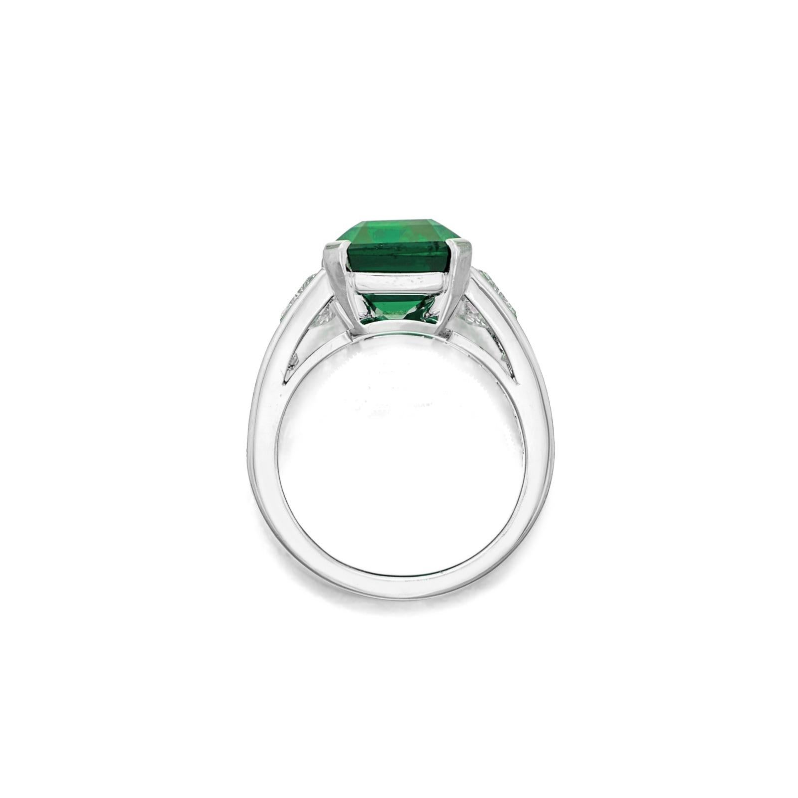 GRS Certified 7.63 Carat Vivid Green Emerald Diamond Ring

This exquisite ring features a breathtaking 7.63 carat Vivid Green  emerald, GIA certified for its exceptional quality and vibrant color. The emerald is beautifully flanked by trapezoid side