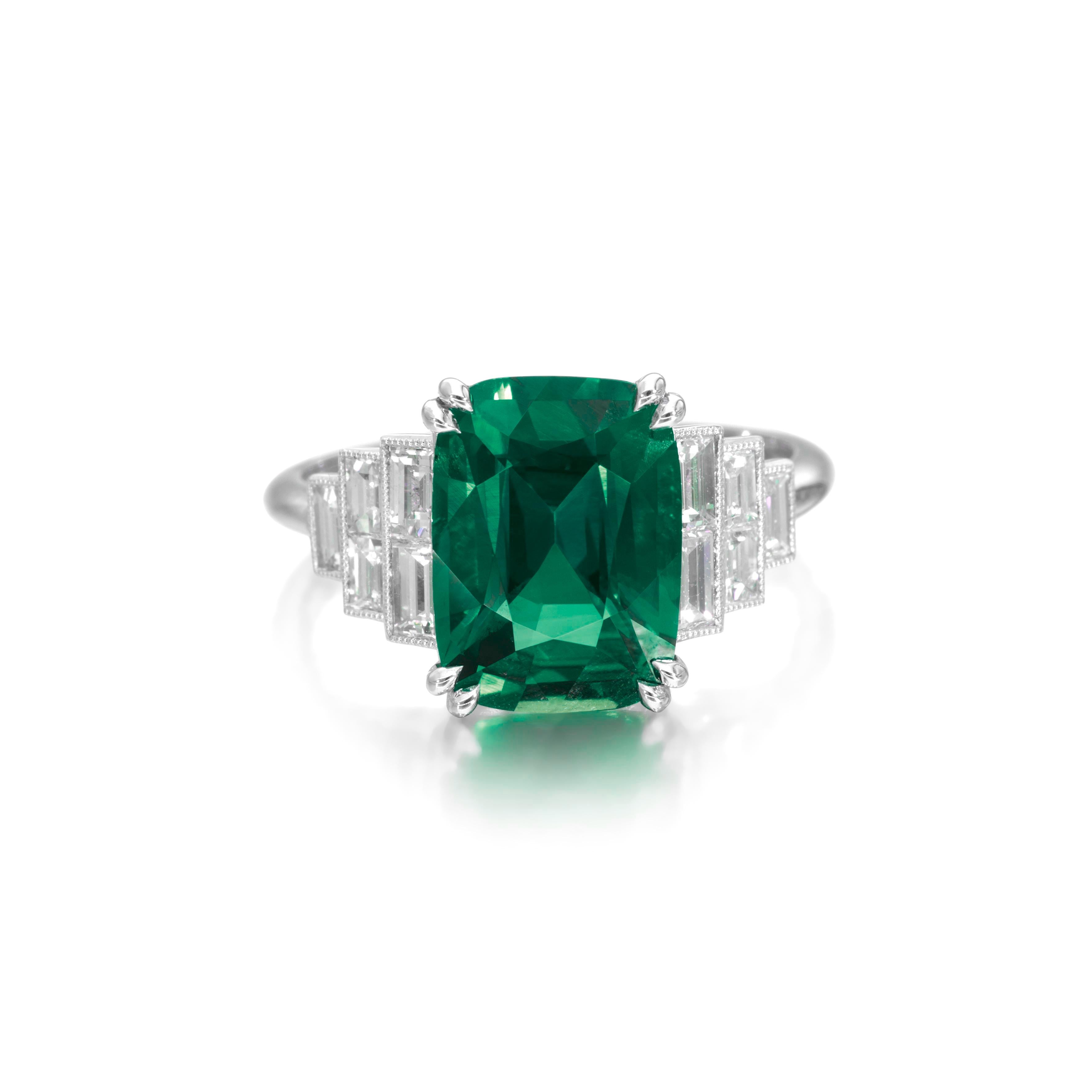 Experience unparalleled sophistication with our AGL-certified Cushion Cut Natural Emerald Ring, where timeless beauty meets modern allure. The ring features a stunning 5-carat Cushion Cut Emerald as its centerpiece, exuding unmatched grace.