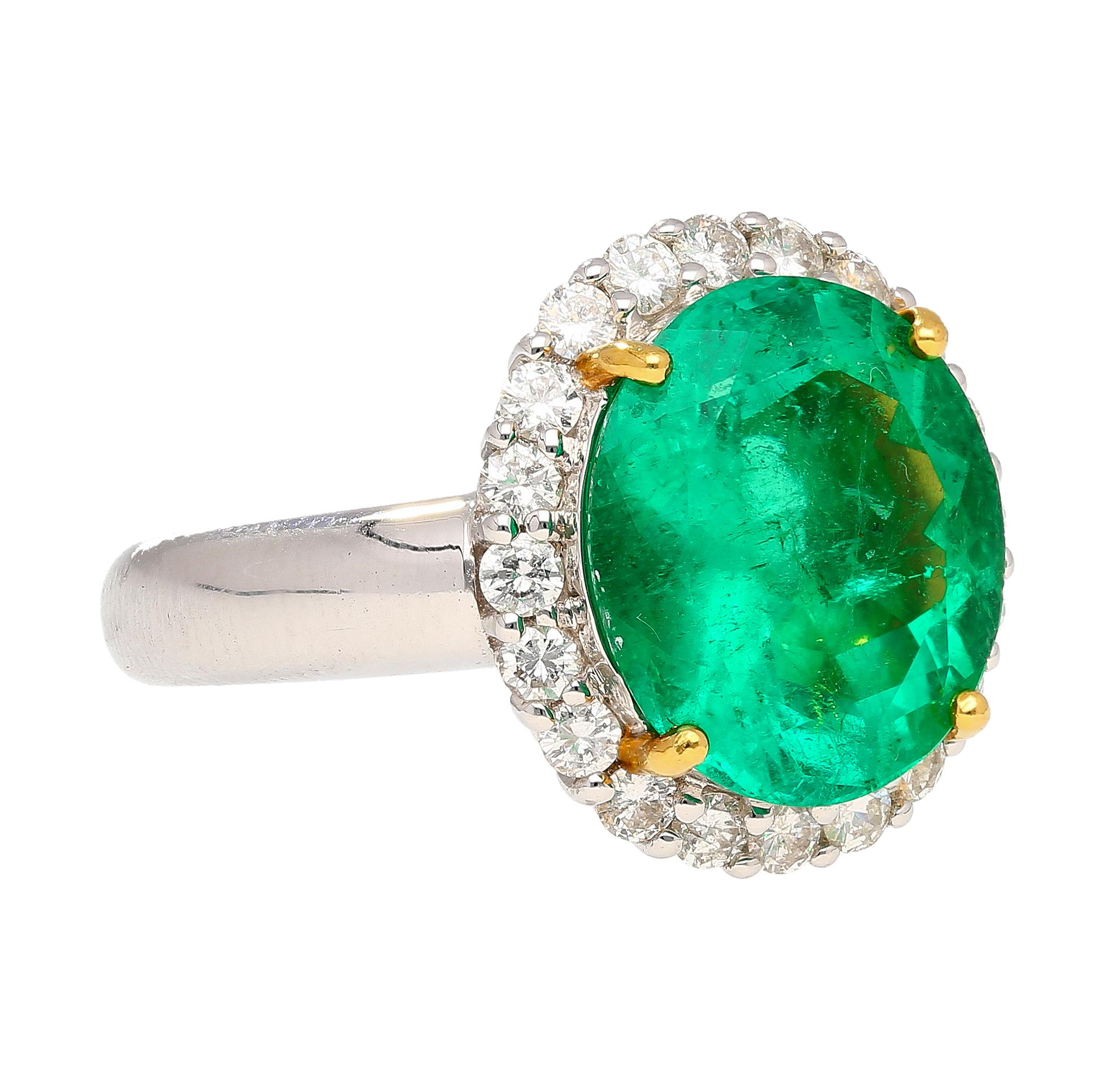 GRS certified 5.03-carat oval cut Colombian Emerald and round cut white diamond halo ring in 18k white gold. The center stone Emerald bears minor oil treatment and a faceted oval cut shape. The stone is eye-clean and full of life. Complemented with
