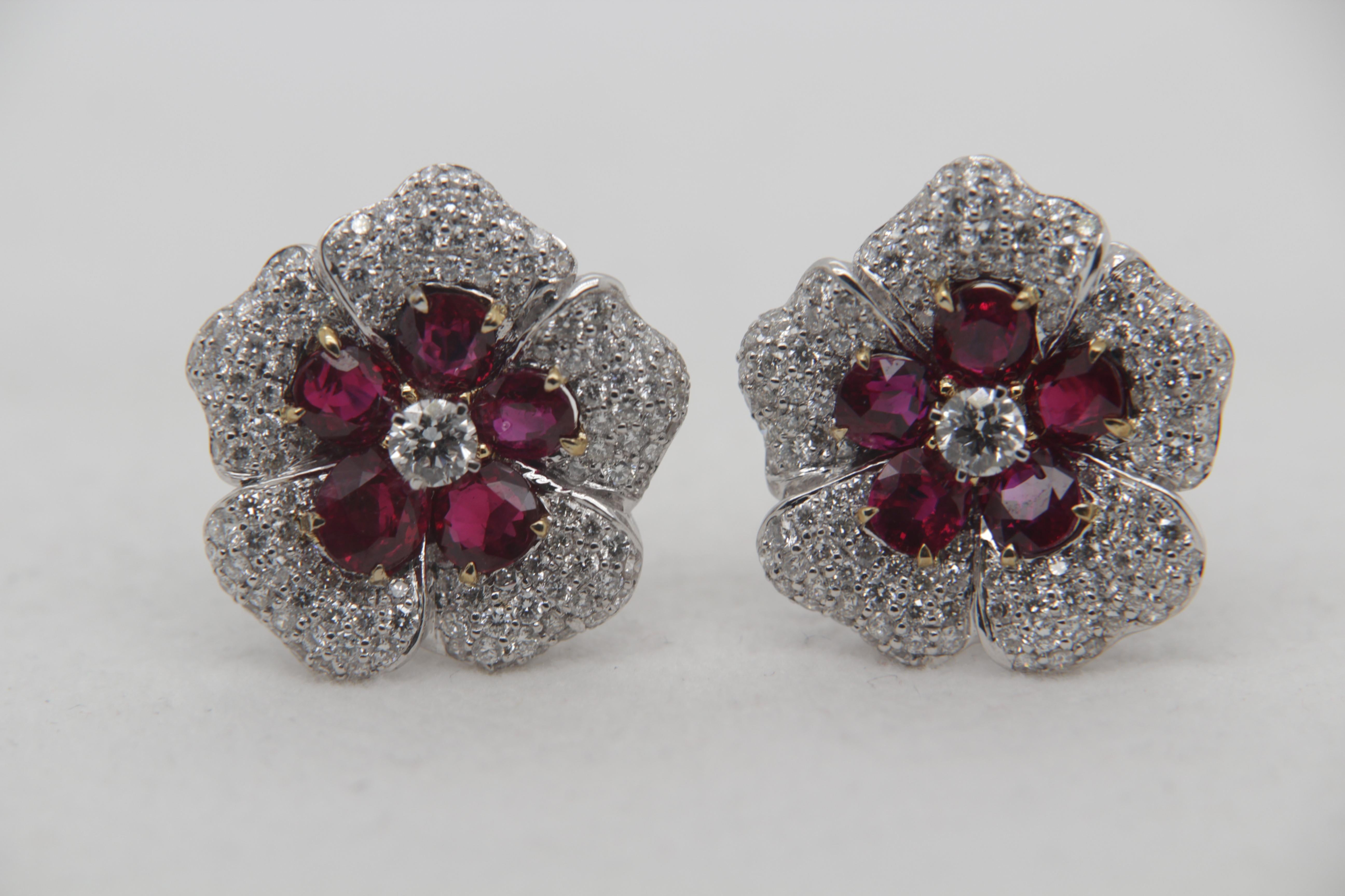 A brand new ruby and diamond earring in 18k gold. The total ruby weight is 5.04 carats for ten pieces and one piece weight 0.49 cts. is certified by Gem Research Swiss lab (GRS) as natural, no heat, and 'Vivid Red Pigeon's Blood' . The total diamond