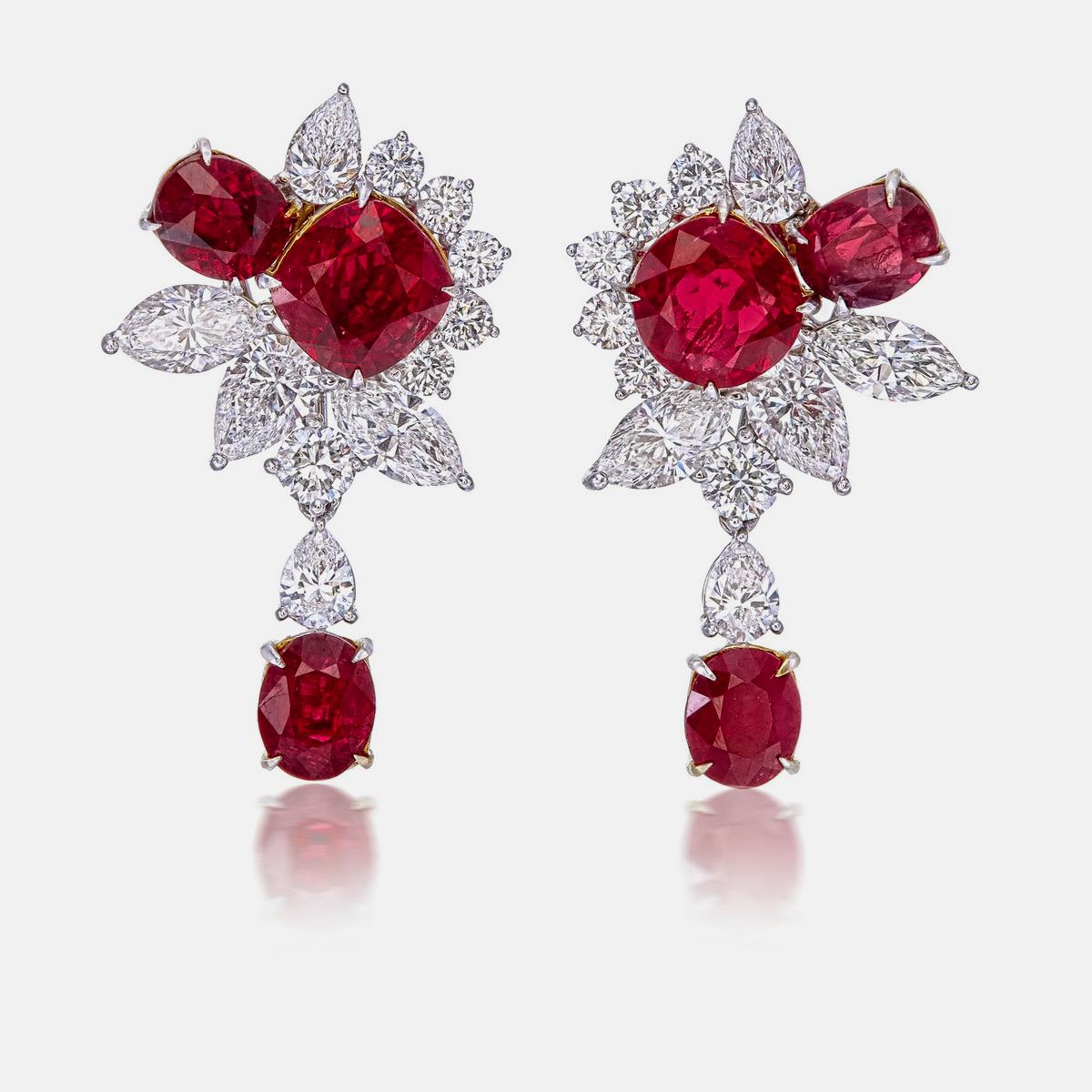 A classic bouquet pigeon blood ruby and diamond earrings, each with a three ruby symphony. Certified by GRS (Gem Research Swisslab) as pigeon blood for the fiery hue radiating from the ruby. This unique design will become a go-to for your jewelry