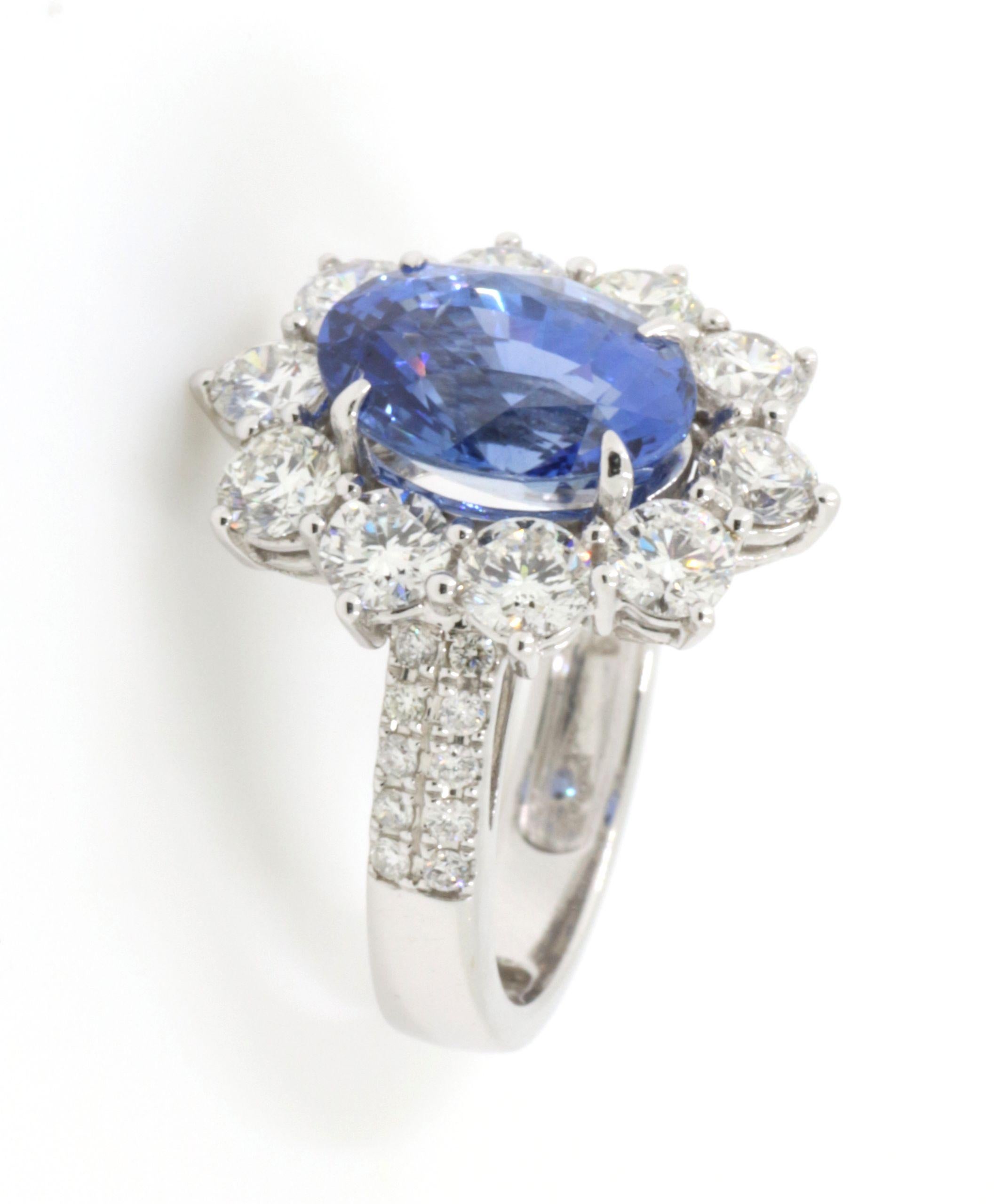This luxurious ring is a true treasure, featuring a breathtaking GRS certified Sri Lanka blue sapphire, weighing 5.55 carats. The sapphire's rich, deep blue is reminiscent of the ocean's depths, offering a mesmerizing centerpiece that is both bold