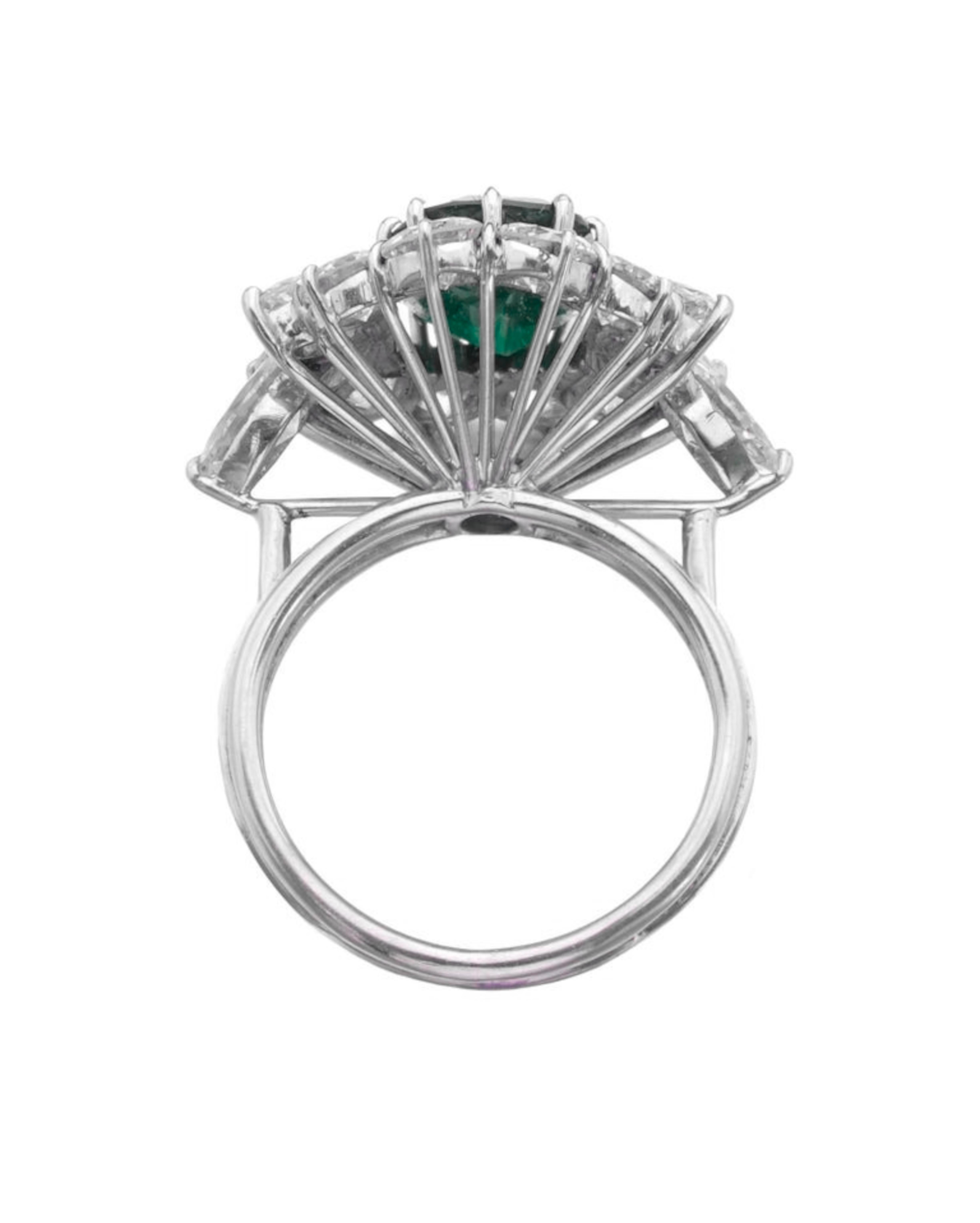 A tribute to timeless glamour and natural elegance, this exquisite ring centers a vivid green 3.57 carat natural emerald of Zambian origin, GRS-certified with insignificant clarity enhancement. The oval brilliant/step-cut emerald exhibits beautiful