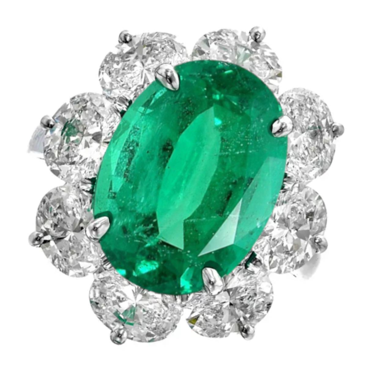 This extraordinary ring showcases a vibrant natural emerald weighing 7.30 carats, certified by GRS as originating from Zambia. The emerald, with its vivid green color and insignificant enhancement (CE(O)), is expertly cut in an oval shape, radiating
