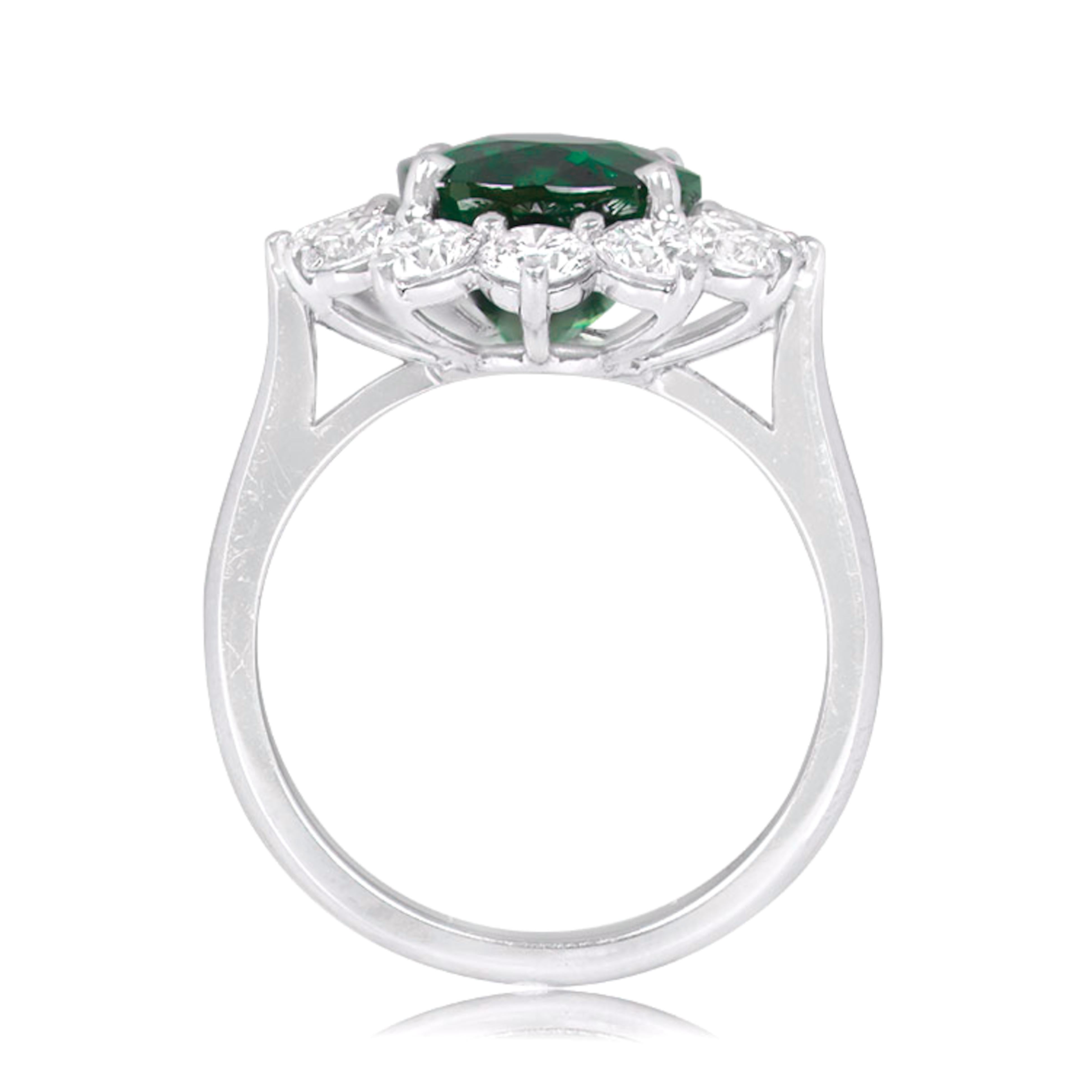 Centering a oval-shaped emerald, flanked by 12 oval-shaped diamonds, decorated throughout with round diamonds.

emerald weighing 7.33 carats
Minor Oil
Size 6
Platinum
Accompanied by Grs report stating that the emerald is of Zambian origin, with