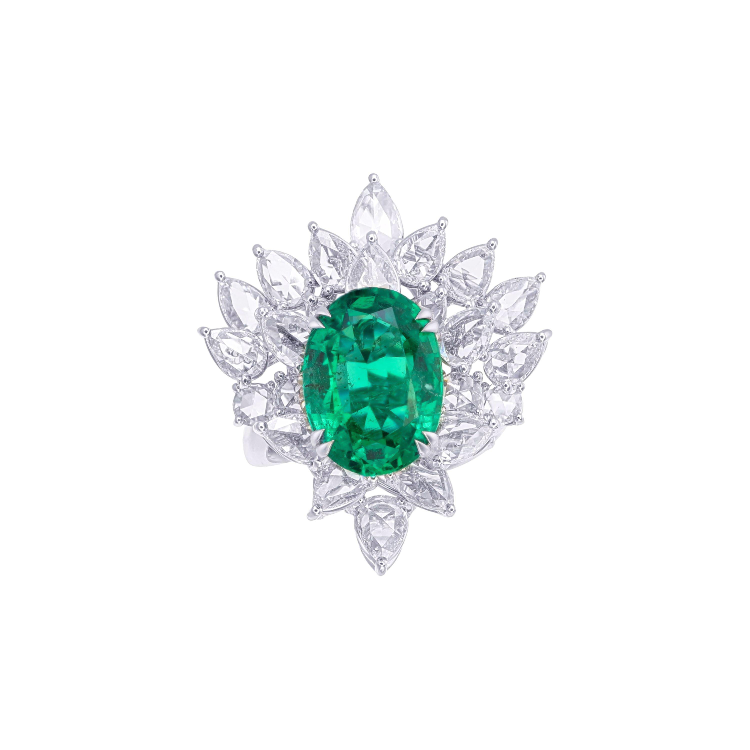 Indulge in the epitome of luxury with this extraordinary statement ring, centered by a breathtaking 5.87-carat Zambian emerald, renowned for its vivid, mesmerizing green hue. This oval-cut gemstone, certified by GRS (GemResearch Swisslab) with minor