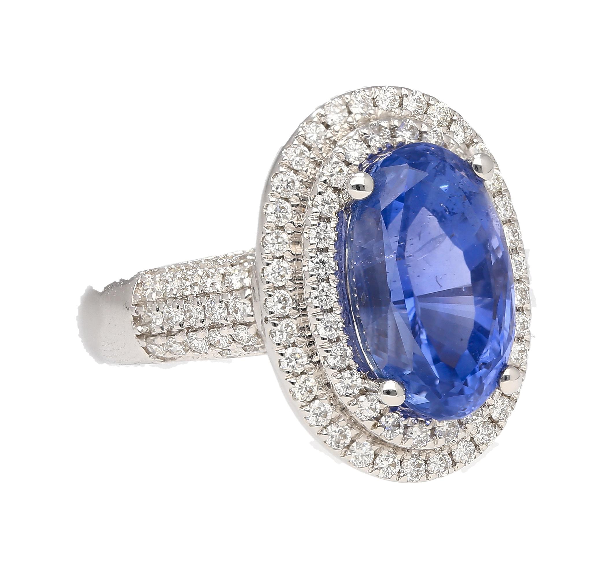 18k white gold natural blue sapphire and diamond halo ring. Featuring a center stone of immaculate color and quality. Sri Lanka origin, richly dense in color hue, and no heat treatment of any kind. This sapphire bears the ideal measurements that