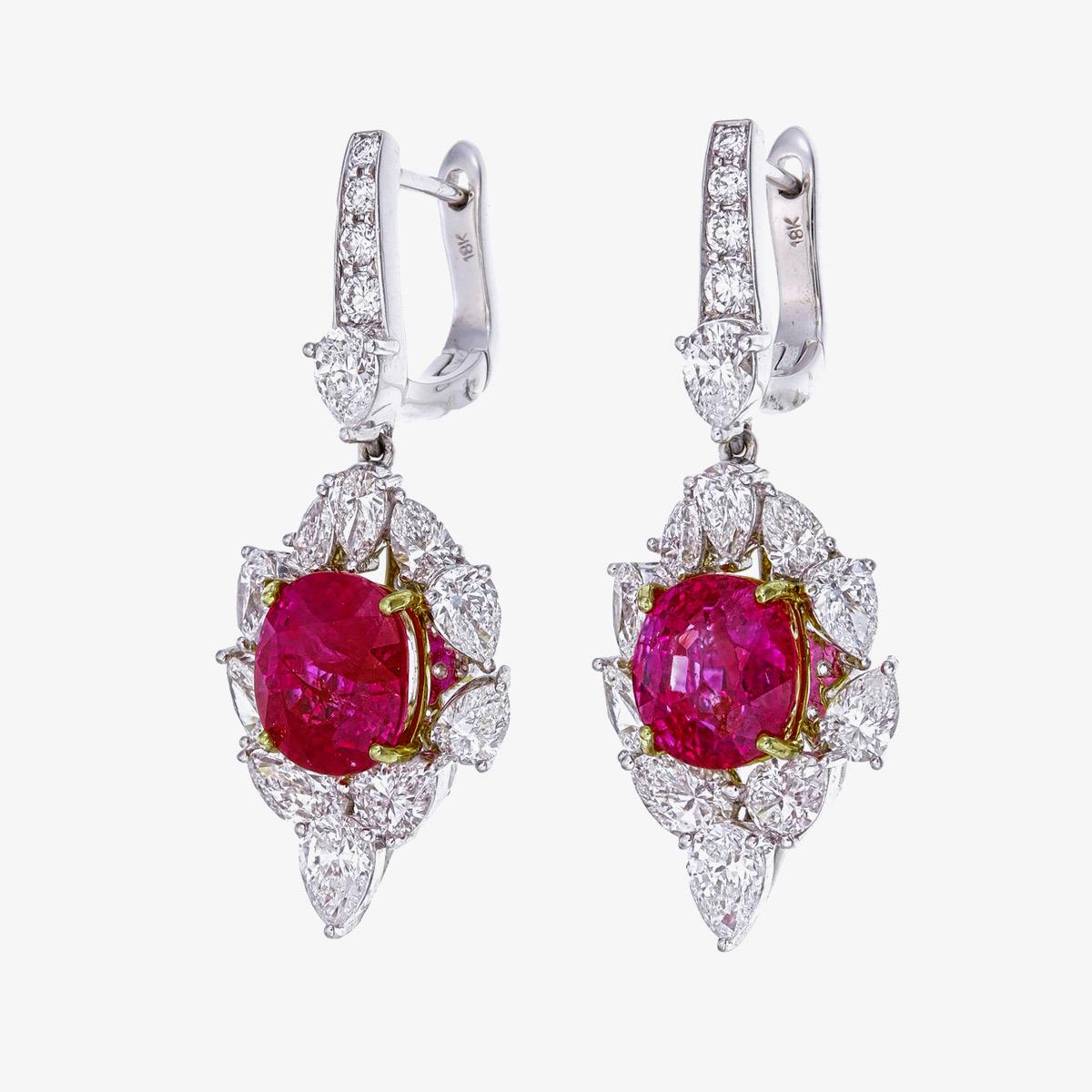 Une élégante  Les boucles d'oreilles en rubis et diamants présentées par REWA sont fabriquées à la main en or blanc 18 carats.

Il comporte deux pièces centrales de forme ovale  Rubis de Birmanie sans chaleur d'origine Mogok, de couleur rouge