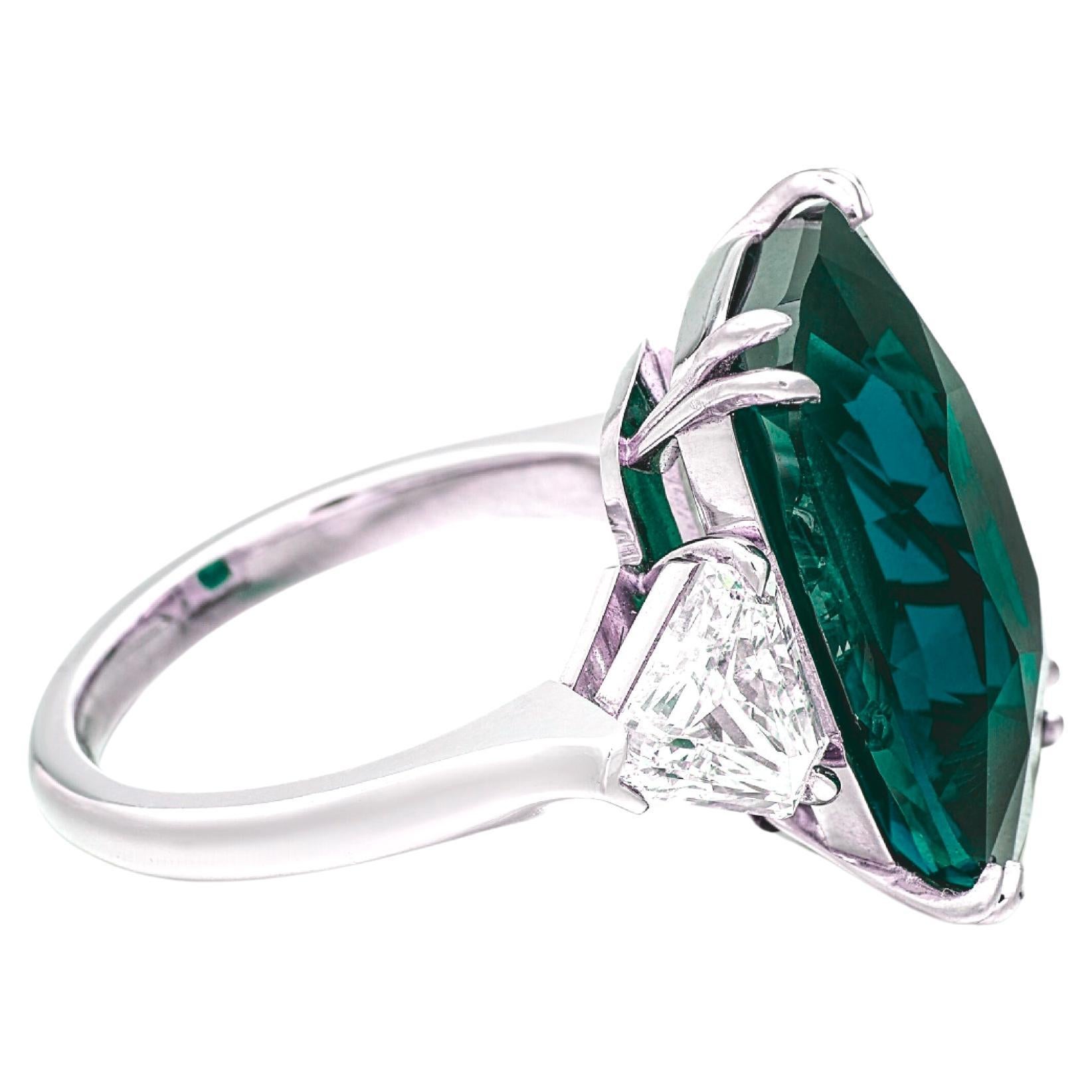 Presenting an exquisite platinum ring featuring a captivating 8.23 carat natural emerald of Zambian origin. Certified by GRS, this exceptional gemstone displays a vivid green hue, masterfully cut in a cushion shape with a brilliant/step cut