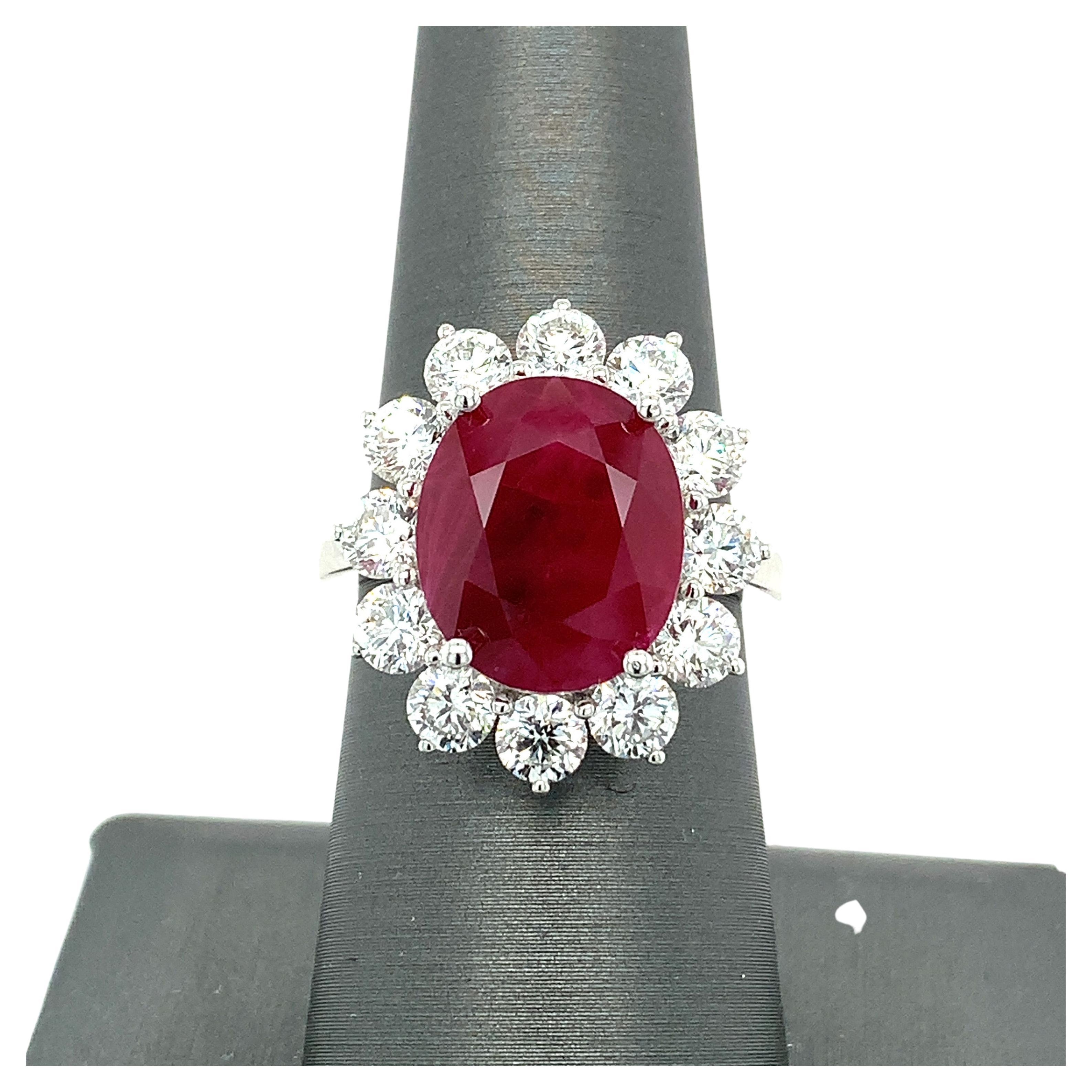 This opulent ring boasts a highly coveted 8.31 carat GRS certified Oval Burmese Ruby surrounded by sparkling halo of 2.80 carat round white diamonds. This Princess Diana inspired ring is hand crafted with the classic four prongs setting in 18K white