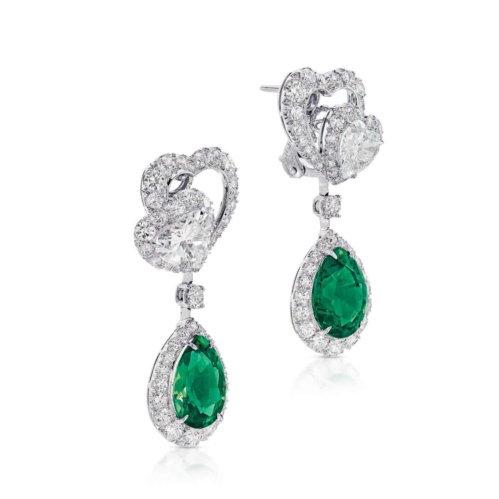 A gorgeous pair of earrings. Each suspending a pear-shaped emerald weighing 3.29 and 3.22 carats, to the heart-shaped diamond-set surmount weighing 1 and 1 carats respectively, embellished with brilliant-cut diamonds, mounted in platinum  post and