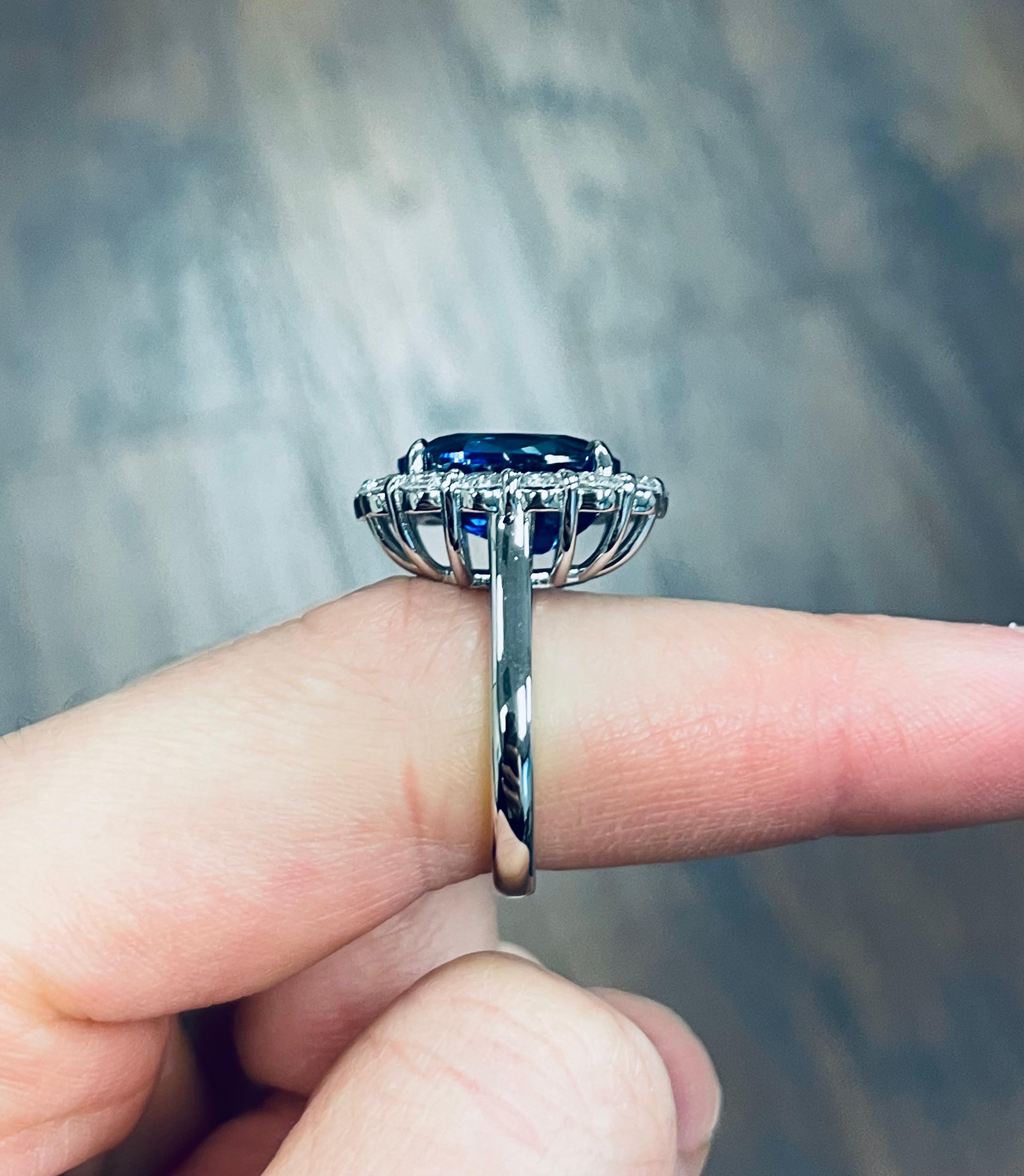Setting:
Halo
Platinum

Center Stone: GRS Certified Oval Cut Sapphire Halo Engagement Ring  
Carat Weight: 9.13
Color: Vivid Blue 
*CERT ATTACHED TO PICTURE SET*

Side Stones: 
Carat Total Weight: 1.68
Color: G-H
14 Stones

•Free Worldwide