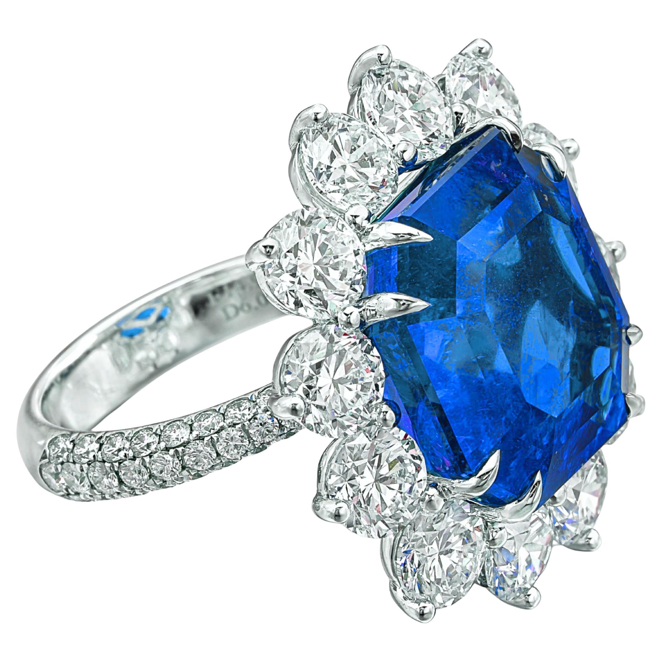 stunning ring set with a step-cut emerald cut blue sapphire, weighing an impressive 9.23 carats. This exquisite stone is certified by GRS, confirming it is untreated, ensuring its natural beauty and vibrant color. 

The sapphire is beautifully