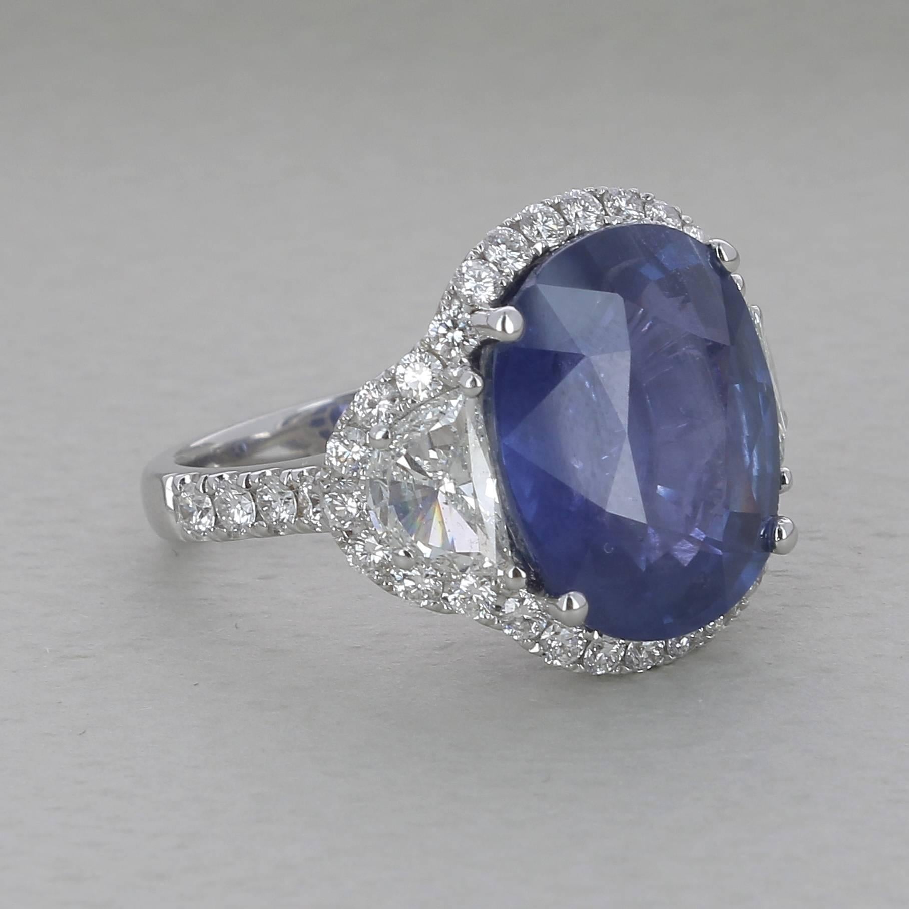 A natural unheated oval shaped blue sapphire weighing 15,96 carats,flanted by 2 half moon diamonds weighing 1,44 carats
All beautifully housed in a shaped halo of sparkling white diamonds 
This ring comes with his GRS Certificate stating there is no