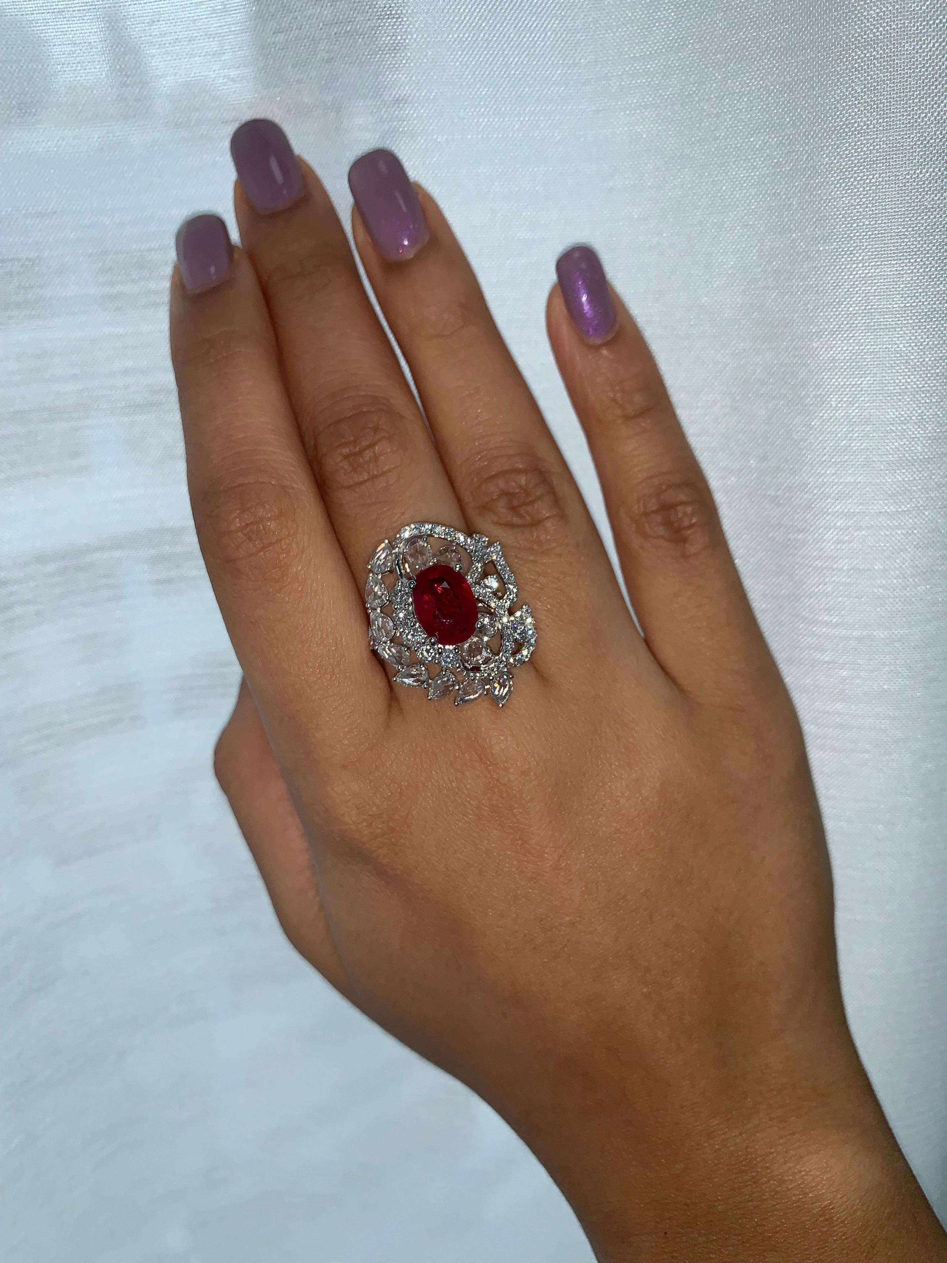 Royal Ruby Ring by Sunita Nahata Fine Design. This beautiful gemstone is unique complemented with floating rose cut diamonds, and pave diamonds on the ring. Regal ring for a special occasion. 

Ruby and Diamond Ring in 18 Karat White Gold.

Ruby
-