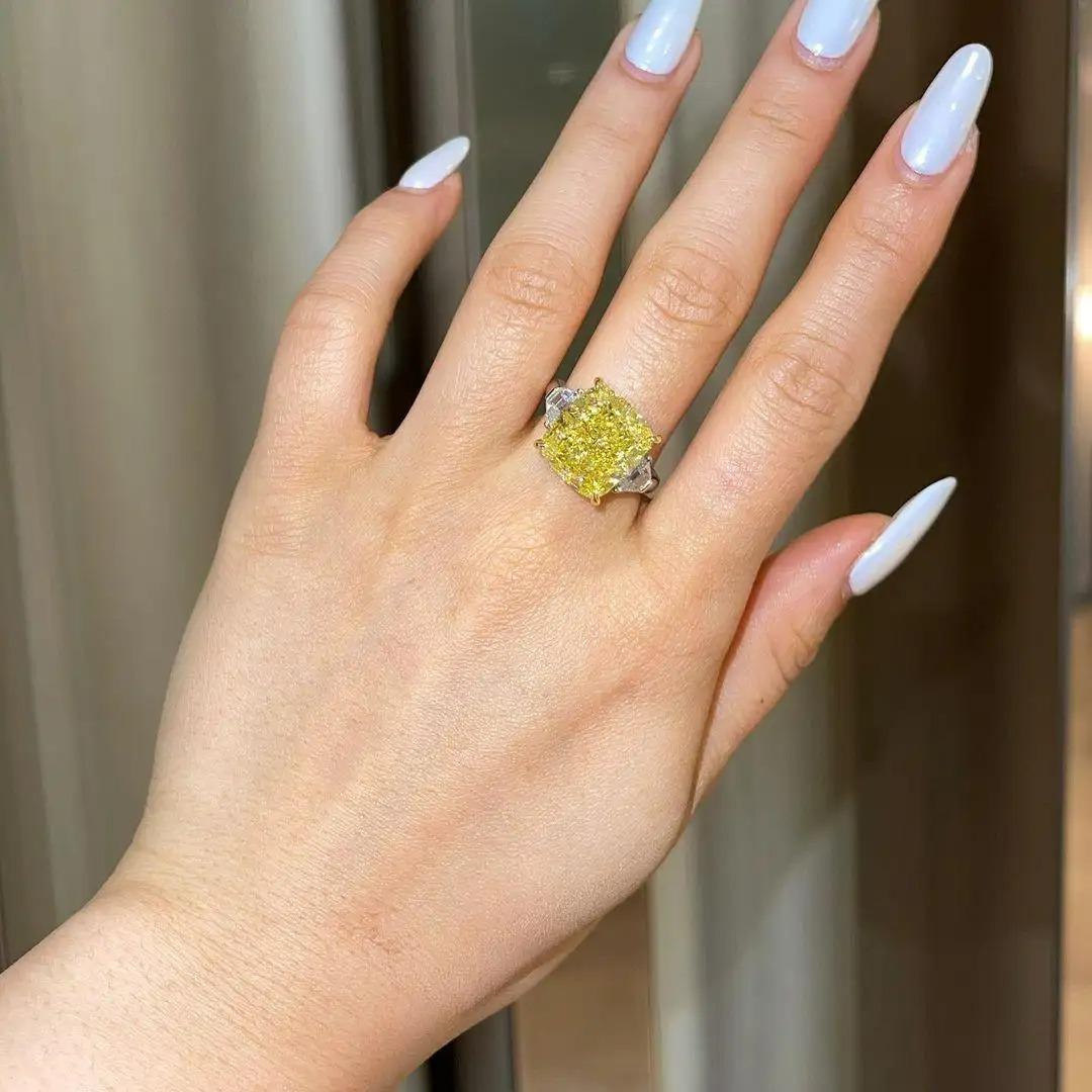Antinori di Sanpietro fancy yellow color Cushion Cut Engagement Ring and this ring is perfection with a 6 carat Fancy Yellow Cushion Cut Diamond of VVS2 clarity, GIA Certified, with F Color side trapezoid cut diamonds in Platinum and 18 karat yellow
