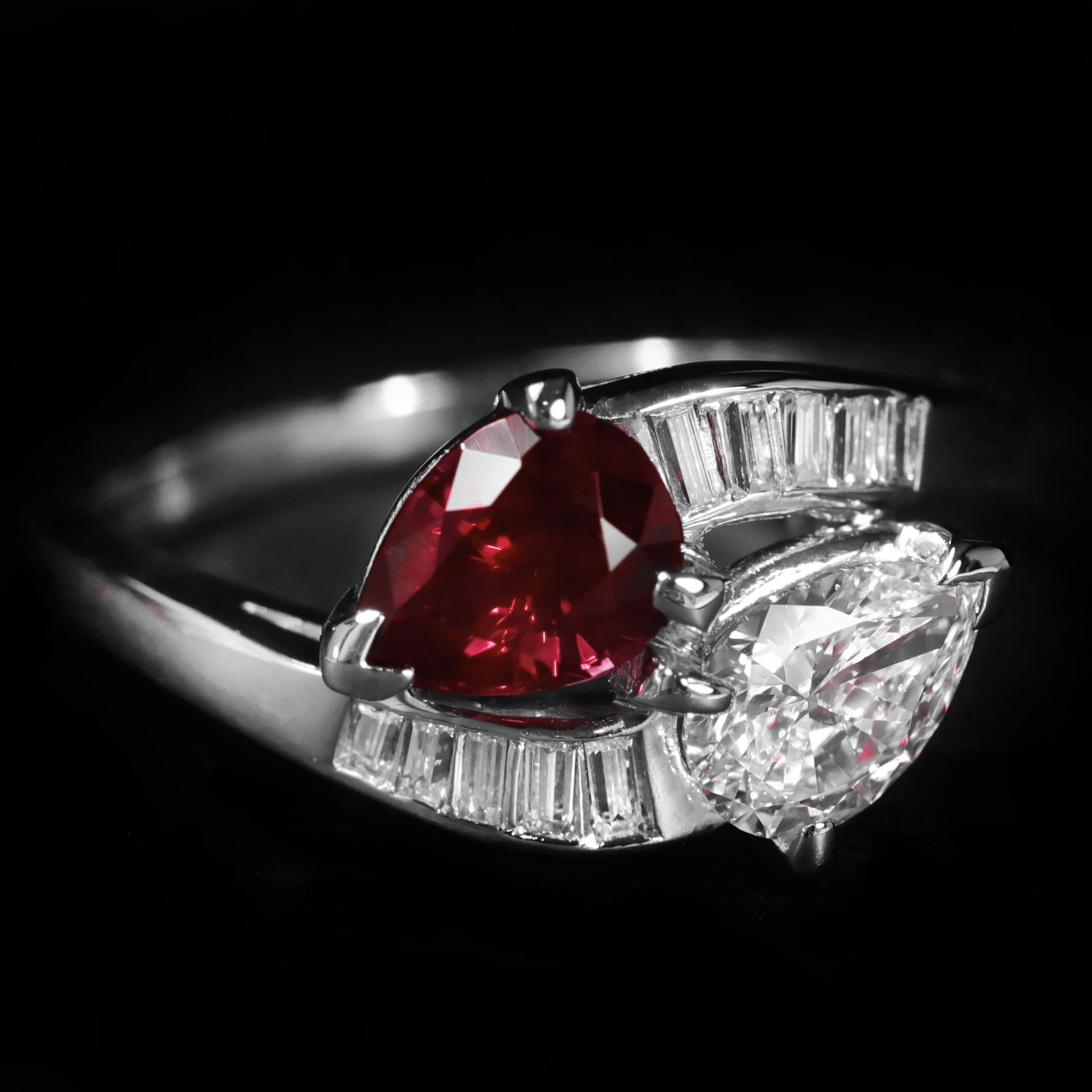 an exquisite piece of jewelry featuring a sophisticated design that incorporates multiple high-quality gemstones. 

It includes a pear-cut diamond and a pear-cut unheated Burmese ruby set side-by-side, symbolizing the union of two hearts. The GIA