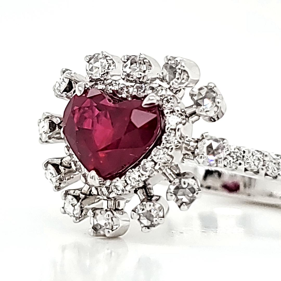 This engagement ring is a mesmerizing testament to love's enduring elegance. 

Nestled at its core lies a pigeon's blood heart-shaped 1.50-carat Ruby from Burma, radiating passion and adorned with the prestigious GRS certification. 

The ring