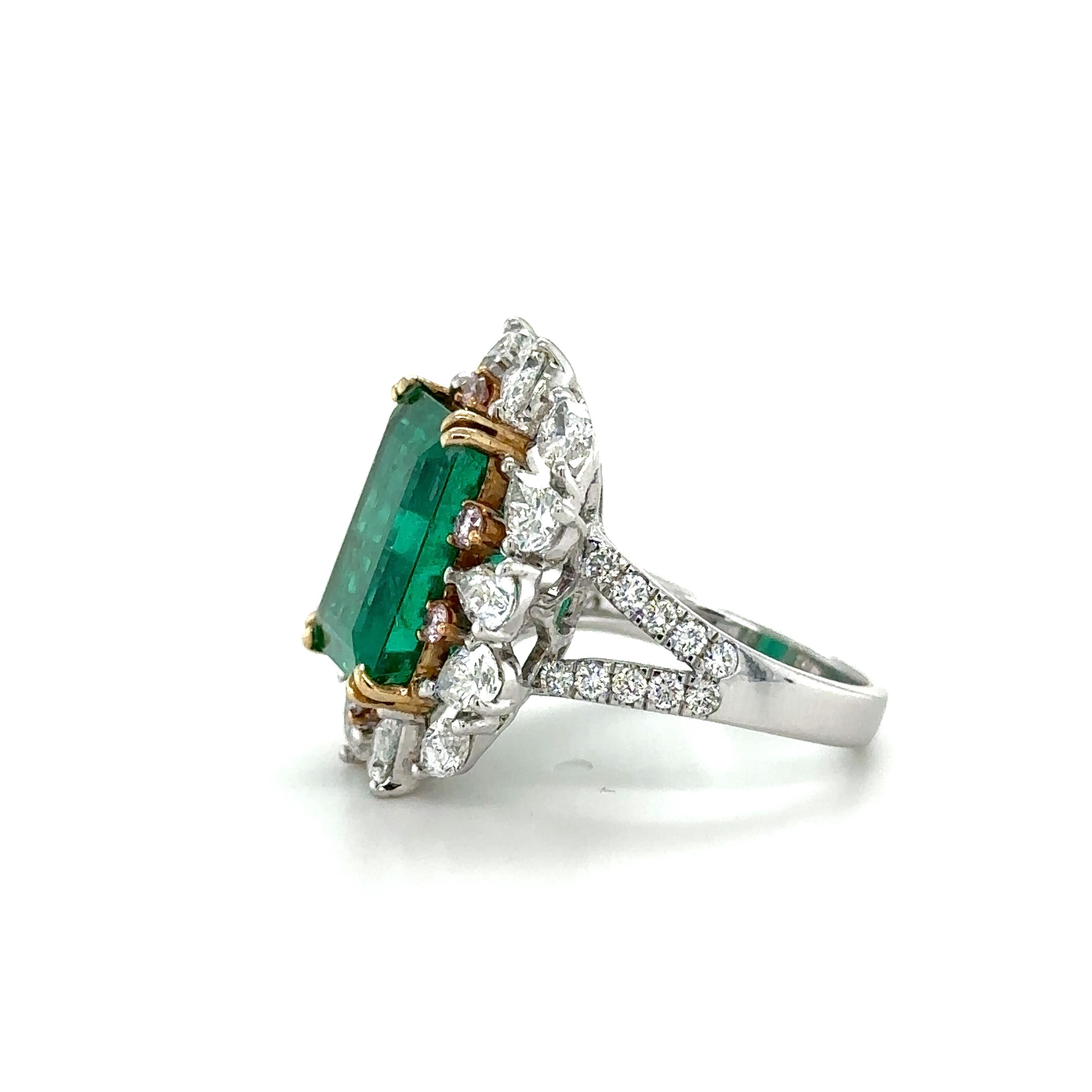 n exquisite ring set in 18 k white gold, featuring a 8.98ct. Emerald-cut Colombian Emerald, surrounded by a total of 2.12ct of pear shape and marquise diamonds, complimented with 0.18ct of rare natural pink diamonds. 

The Emerald is graded green, a