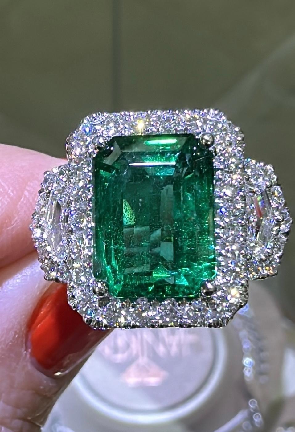 This gorgeous GRS-certified statement ring will make a lasting impression with its show-stopping 5.47-carat Zambian emerald center stone and dazzling diamond accents. This ring is a timeless treasure and a perfect way to express your bold