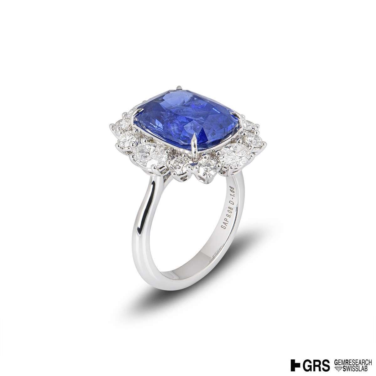 A stunning 18k white gold blue sapphire and diamond ring. The ring consists of a 9.08ct cushion cut natural Cornflower SriLankan blue sapphire, with no indication of heat treatment. Surrounding the sapphire are 4 oval cut diamonds and 8 round