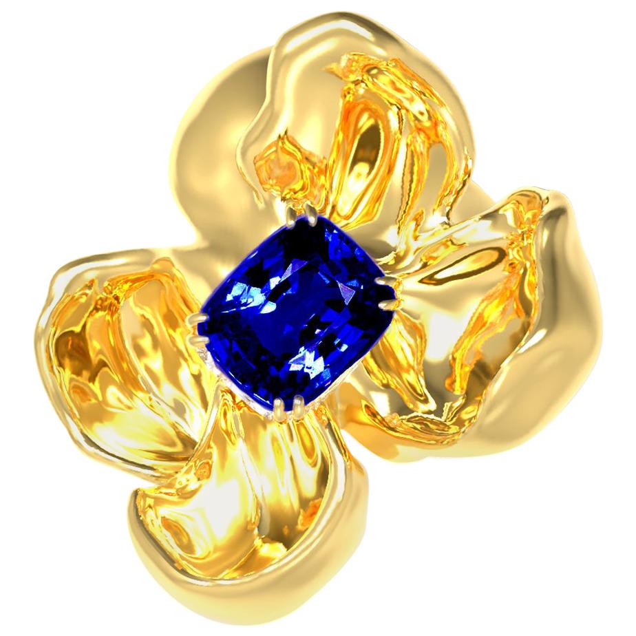 The Magnolia Flower contemporary brooch is crafted from 18 karat yellow gold and features a GRS certified no heat royal blue sapphire with a weight of 1.03 carats. The sapphire has a cushion cut and measures 6.97 x 5.09 x 2.84 mm, exhibiting an